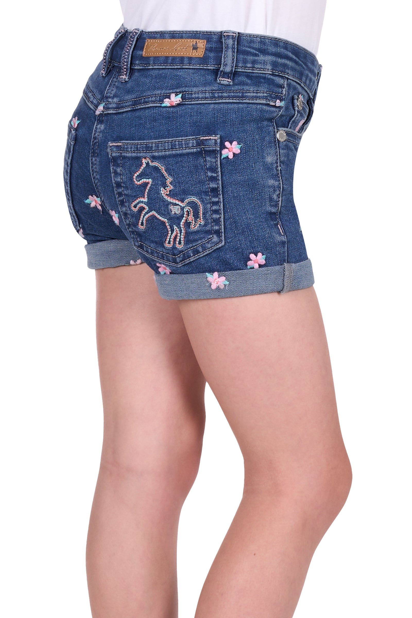 Side view if Thomas Cook Girl's Hailey Denim Short. Blue denim shorts with floral and horse embroidery on a white background