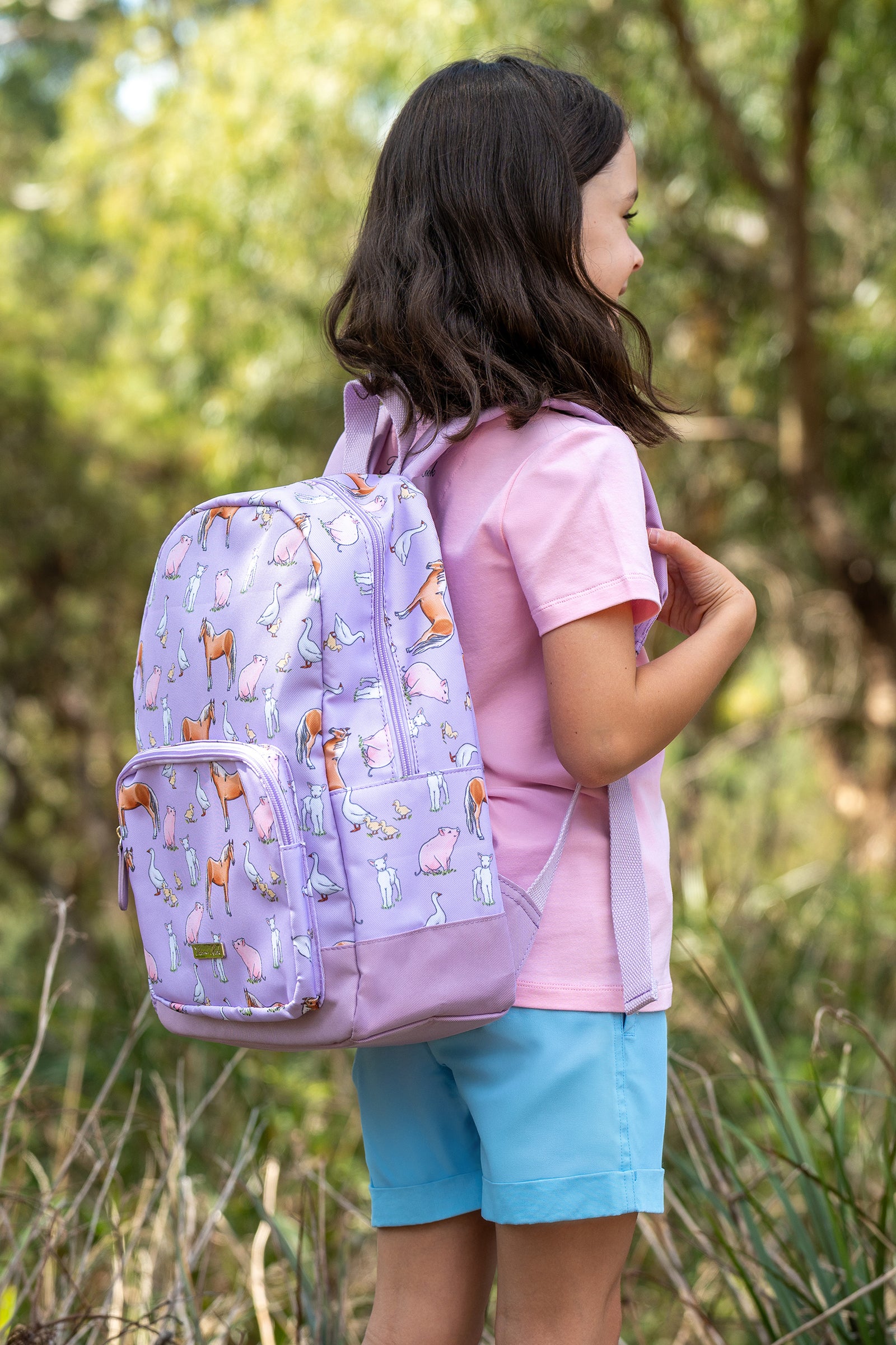 Thomas Cook Layla Backpack. Purple backpack with farm animal pattern on a white background