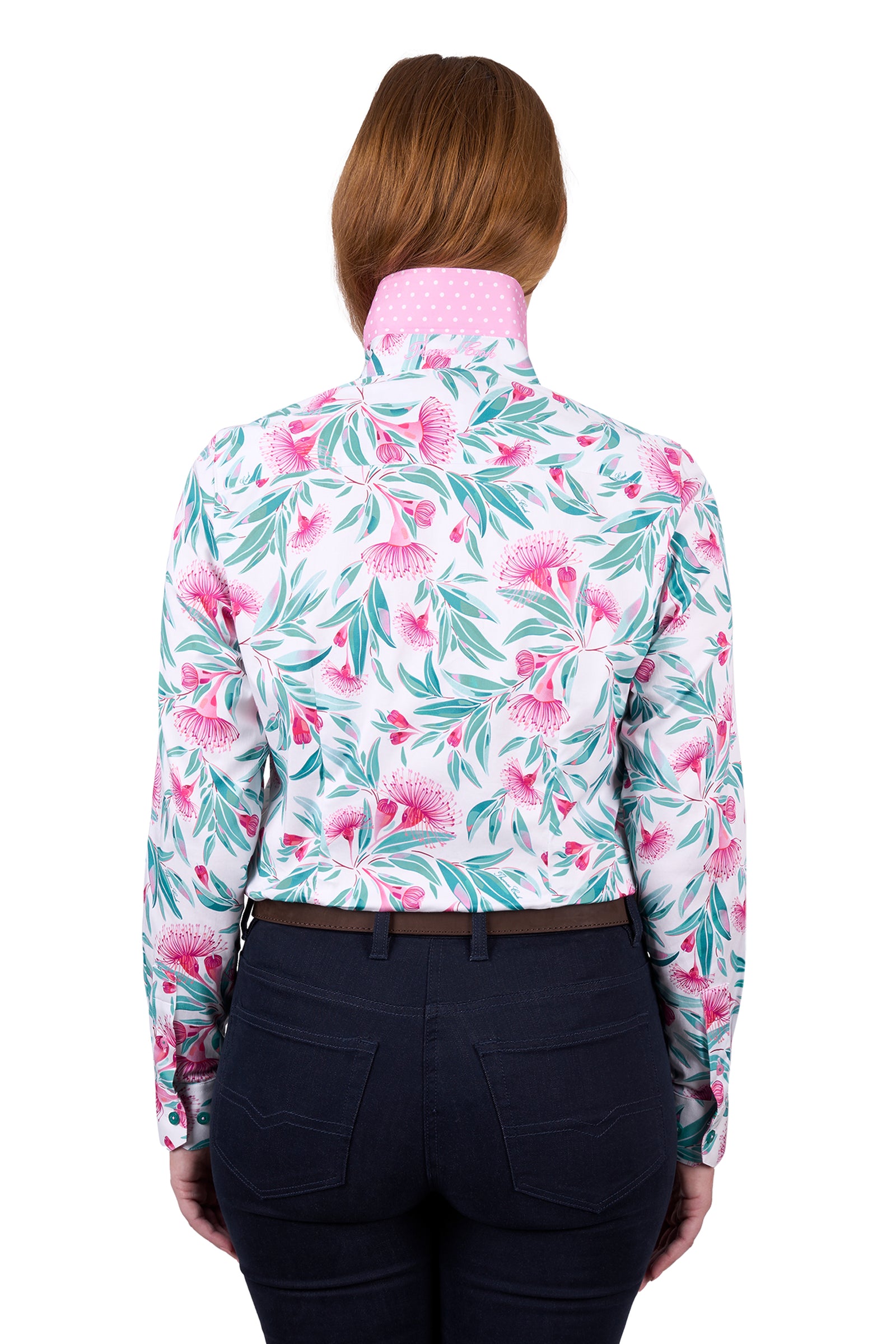 Thomas Cook Women's Florence L/S Shirt. A woman wearing a long-sleeved floral shirt and dark pants. The shirt features a geometric pattern with pink and green colors.