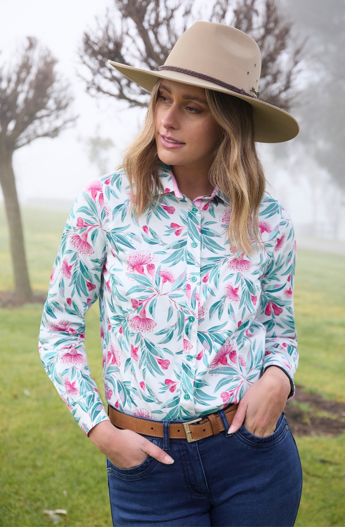 Thomas Cook Women's Florence L/S Shirt. A woman wearing a long-sleeved shirt with a floral pattern. The shirt is primarily white with green and pink floral designs.