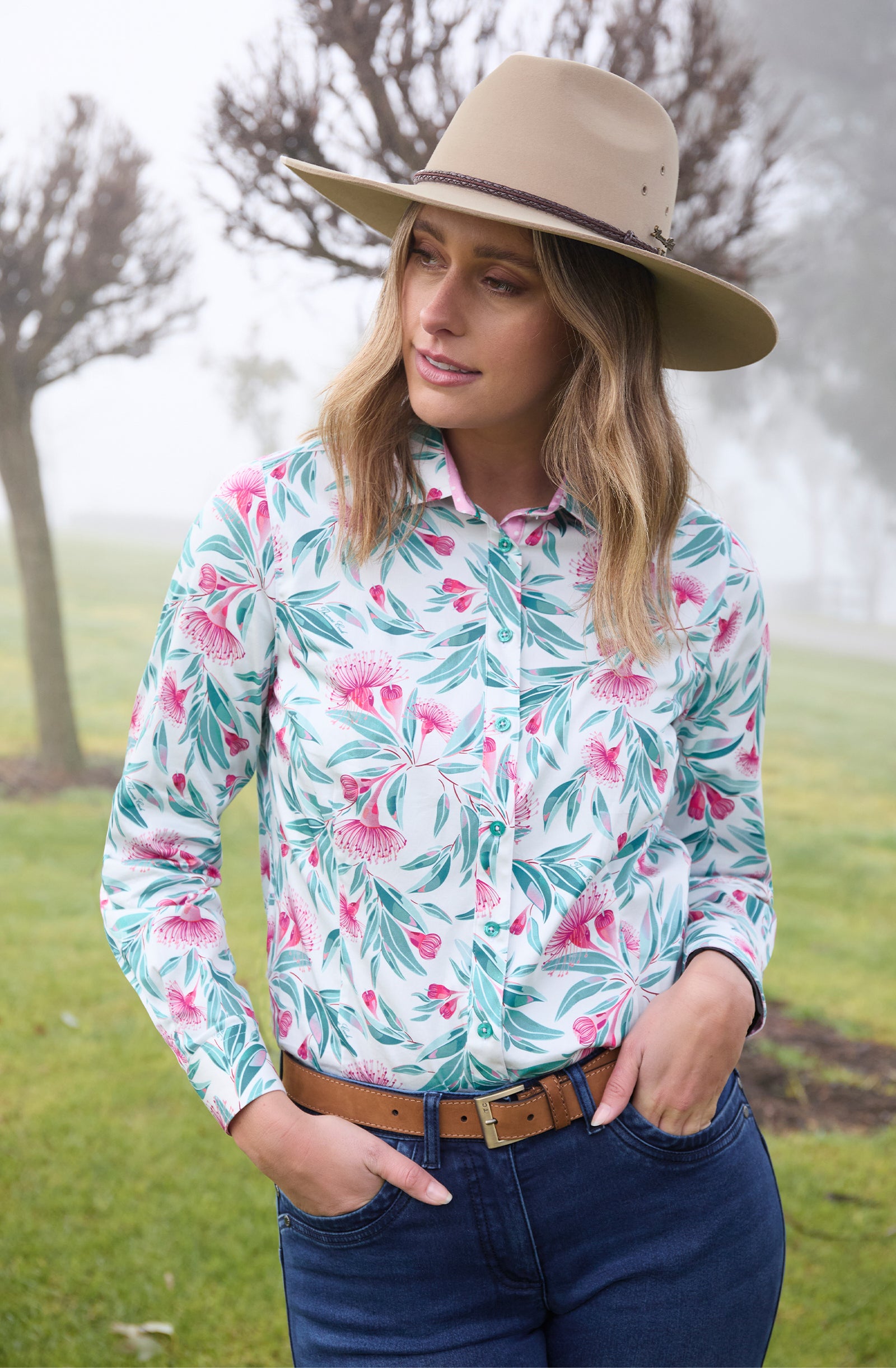 Thomas Cook Women's Florence L/S Shirt. A woman wearing a long-sleeved shirt with a floral pattern. The shirt is primarily white with green and pink floral designs.