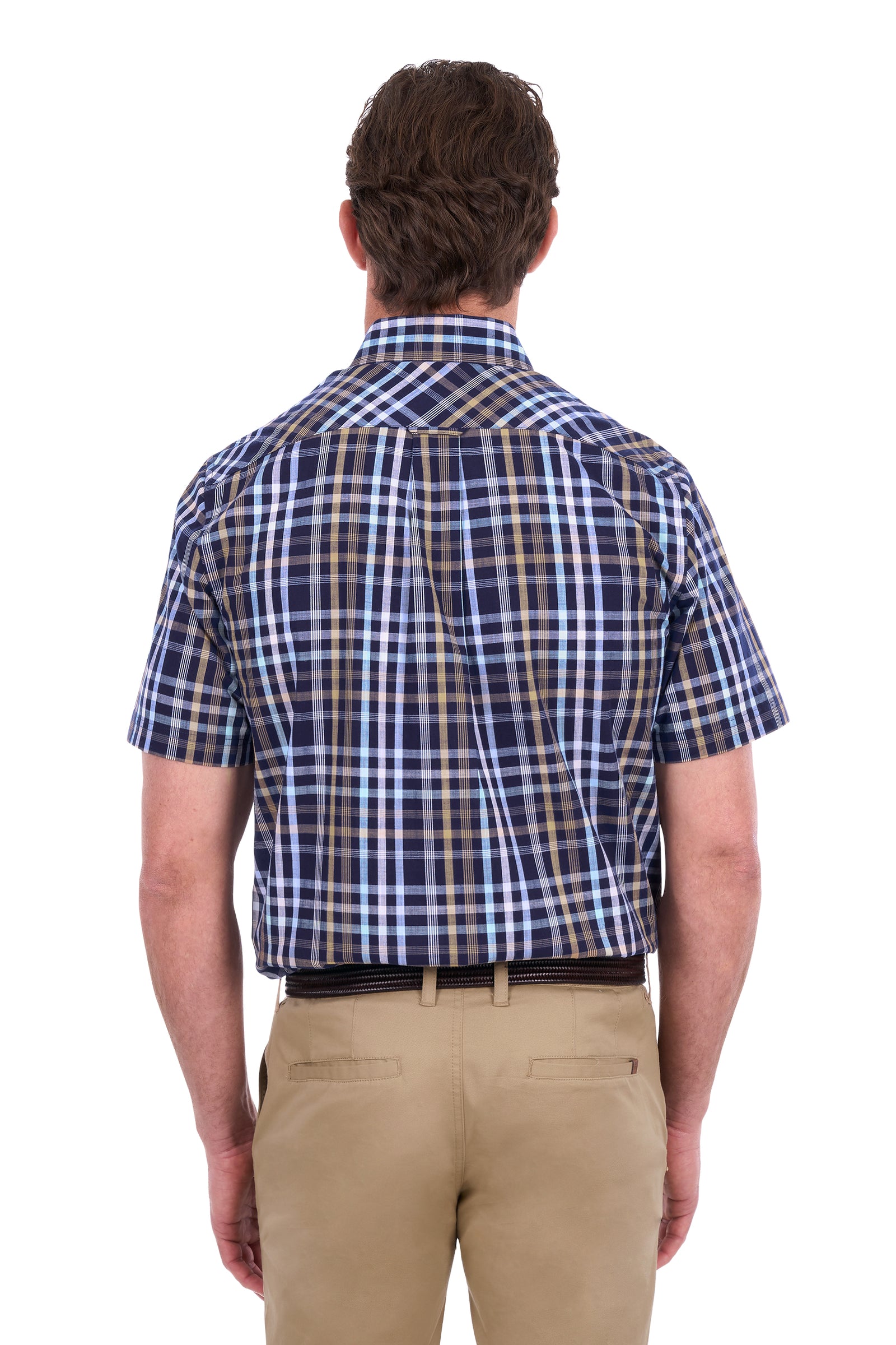 A man viewed from the back wearing a short-sleeve plaid button-down shirt in navy, blue, and tan, paired with khaki pants, against a plain white background.
