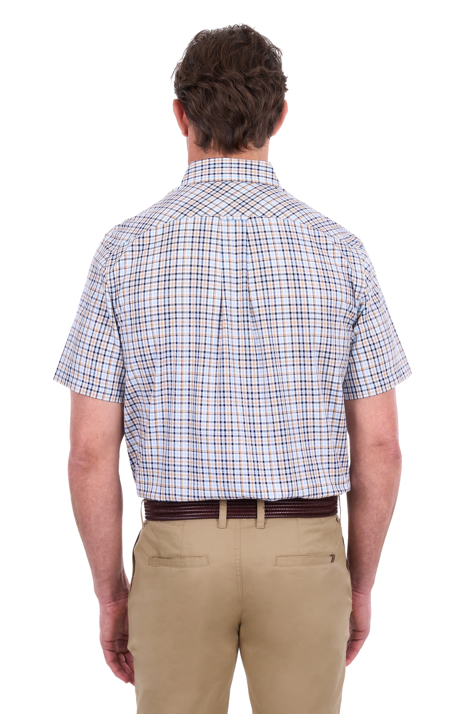 A man viewed from the back wearing a short-sleeve button-down shirt with a white base and a blue and red windowpane plaid pattern, paired with khaki pants and a dark brown belt, against a plain white background.