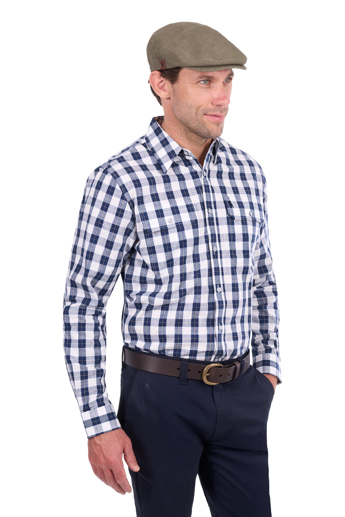 A man wearing a blue and white checkered long-sleeve button-down shirt, navy trousers, a brown belt, and a brown flat cap, photographed against a solid white background.