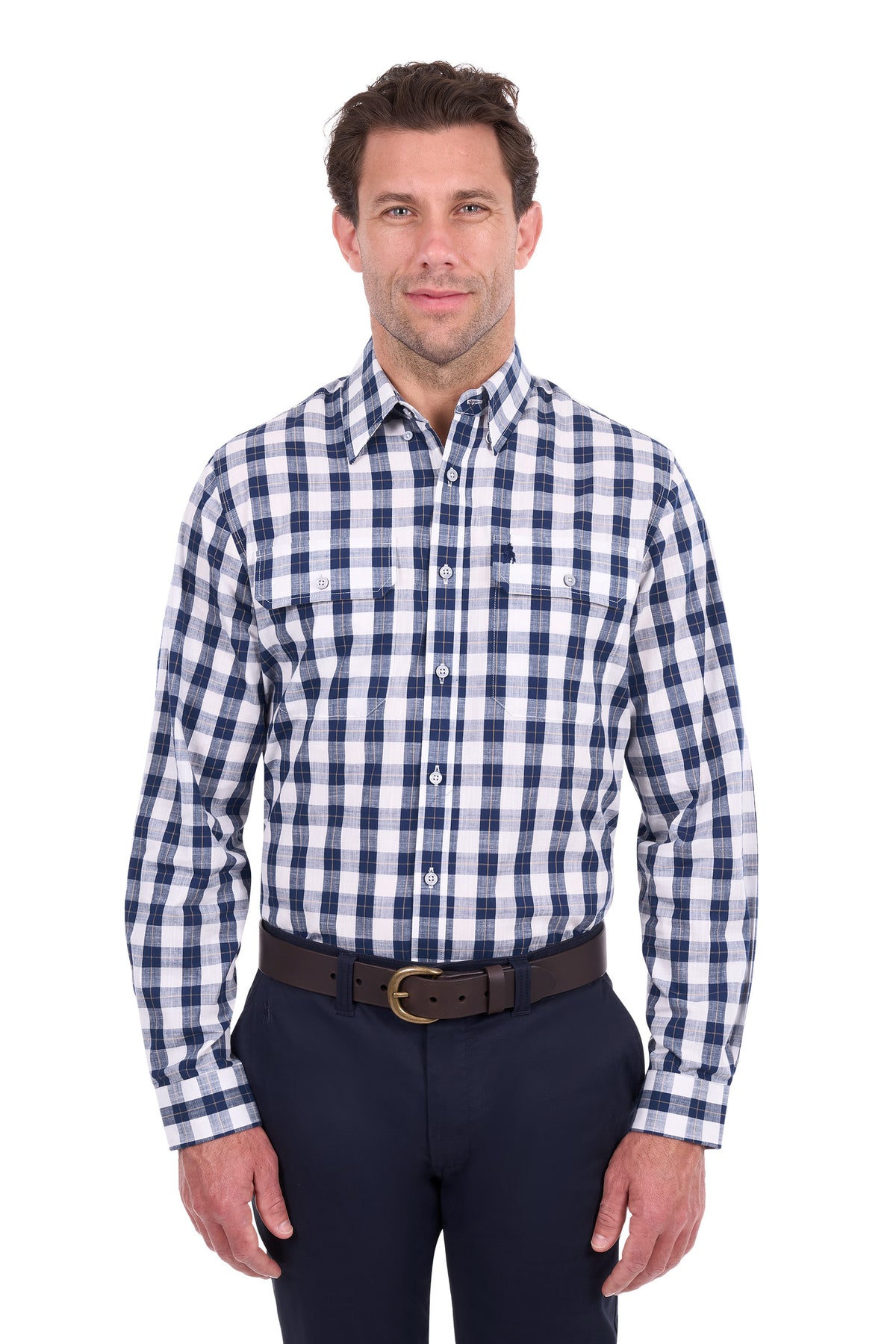 A man wearing a long-sleeve button-down shirt with a navy and white gingham check pattern, paired with dark trousers and a brown belt, standing against a plain white background.