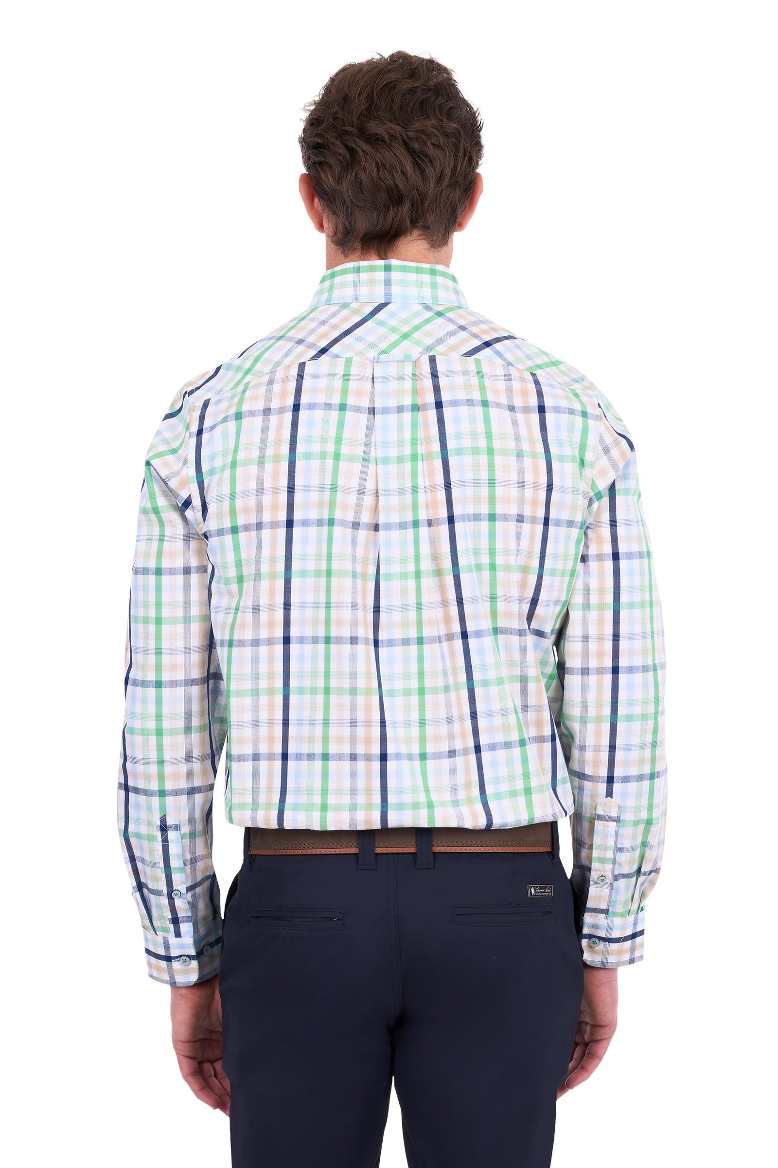 A man viewed from the back wearing a long-sleeve plaid button-down shirt with green, blue, and white stripes on a white base, paired with dark navy trousers.