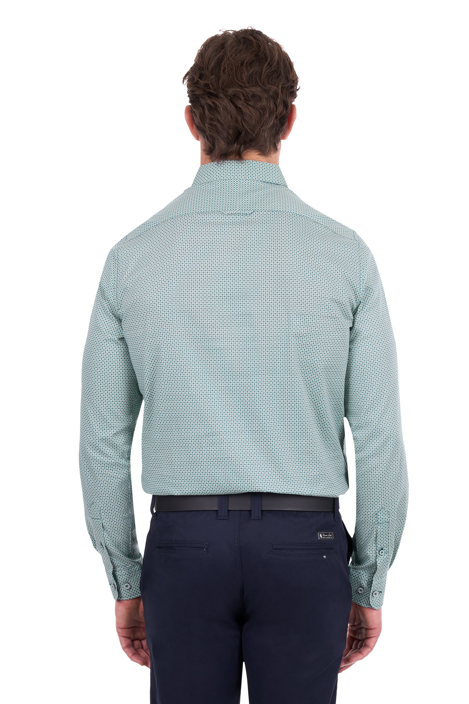 A man viewed from the back wearing a light sage green long-sleeve dress shirt with a subtle micro-pattern, paired with navy trousers and a black belt, against a plain white background.