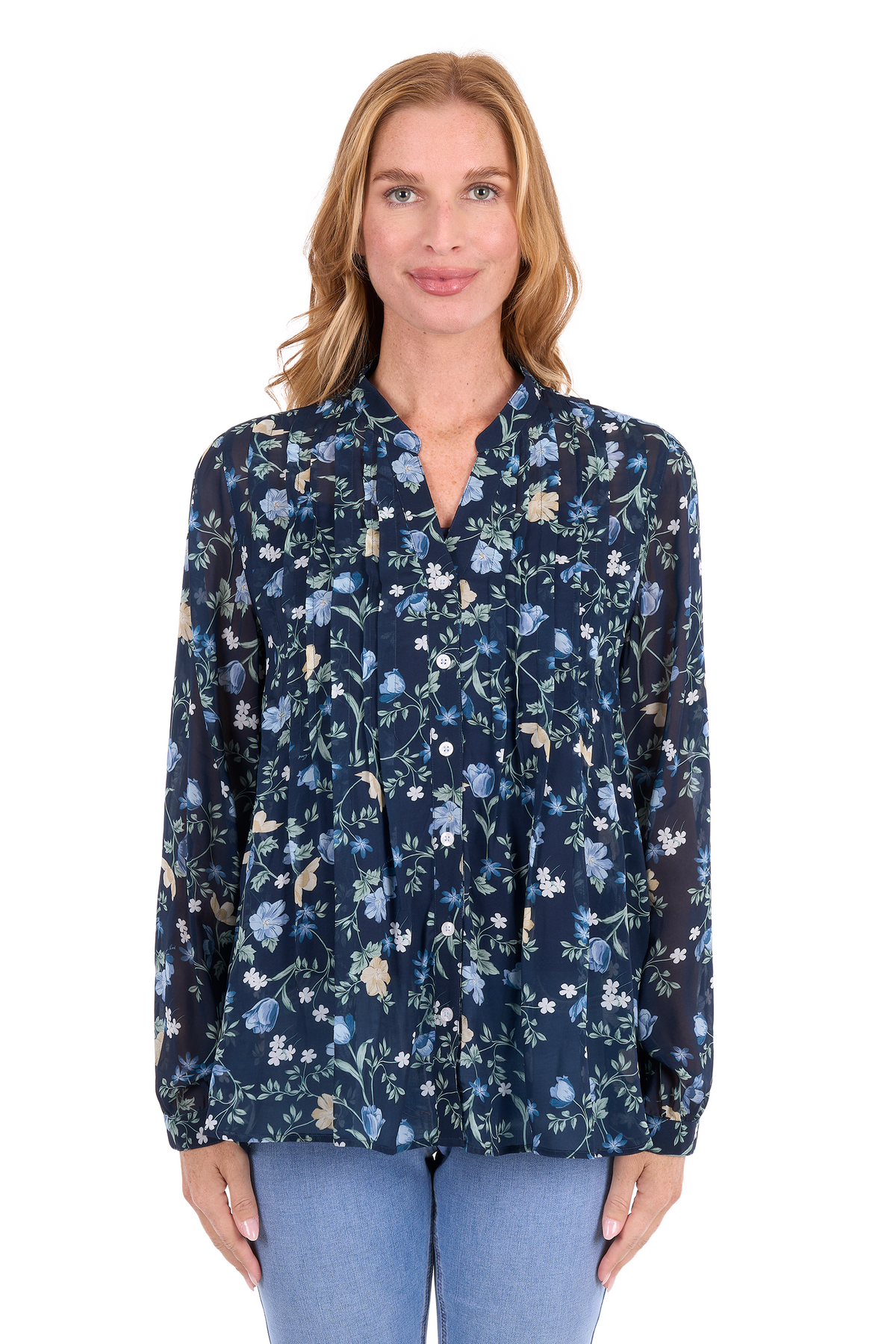 A woman modeling a navy blue long-sleeve blouse with a delicate blue, green, and beige floral print, paired with light blue jeans, against a plain white background.