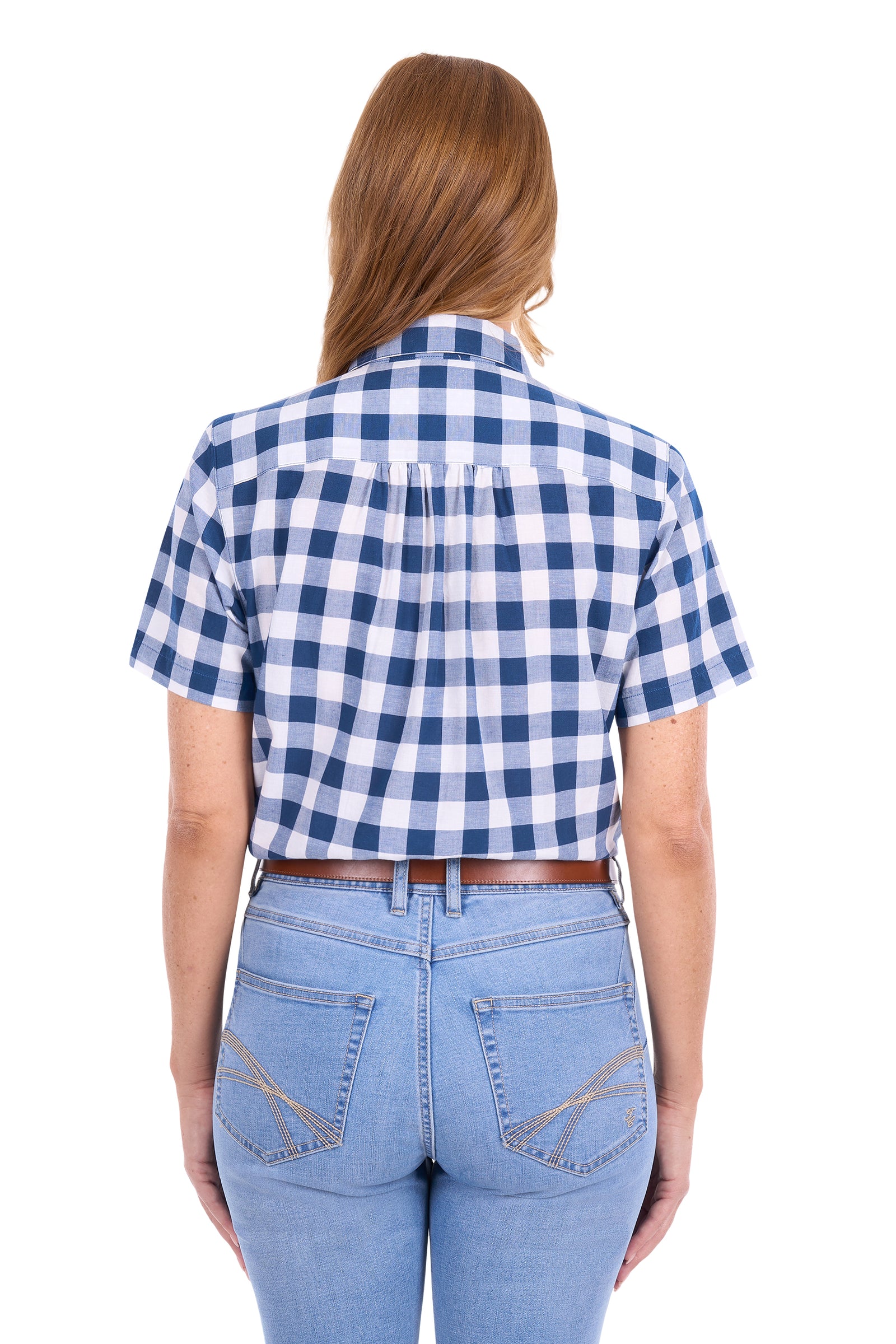 A woman viewed from the back wearing a short-sleeve blue and white gingham check shirt tucked into light-wash blue jeans with a brown belt, against a plain white background.