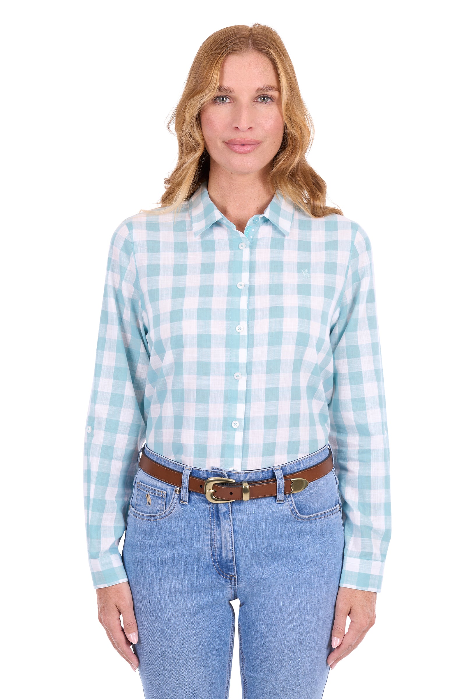 A woman modeling a light blue and white gingham long-sleeve button-down shirt, paired with blue jeans and a brown belt, against a plain white background.