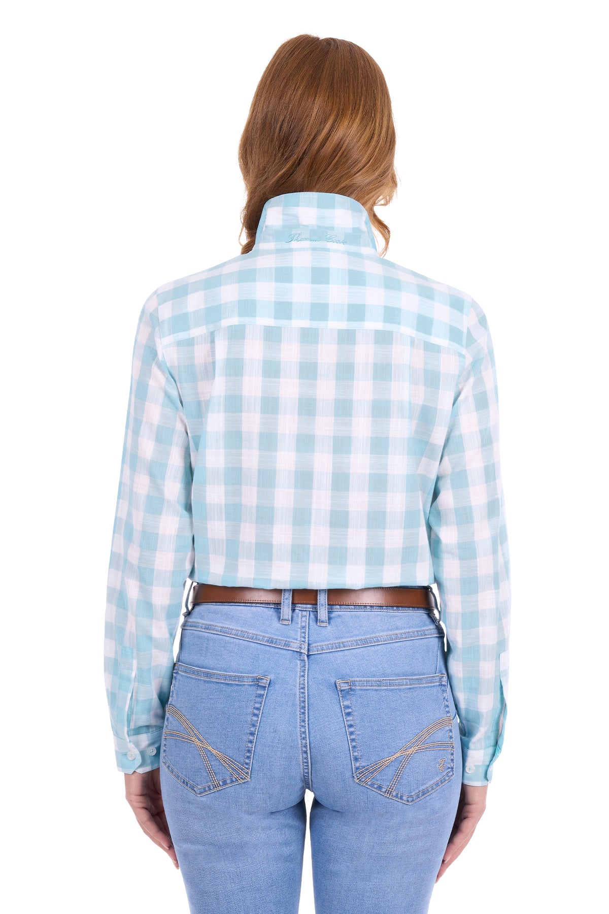 A woman viewed from the back wearing a light blue and white gingham cropped long-sleeve shirt with light blue jeans and a brown belt, against a plain white background.
