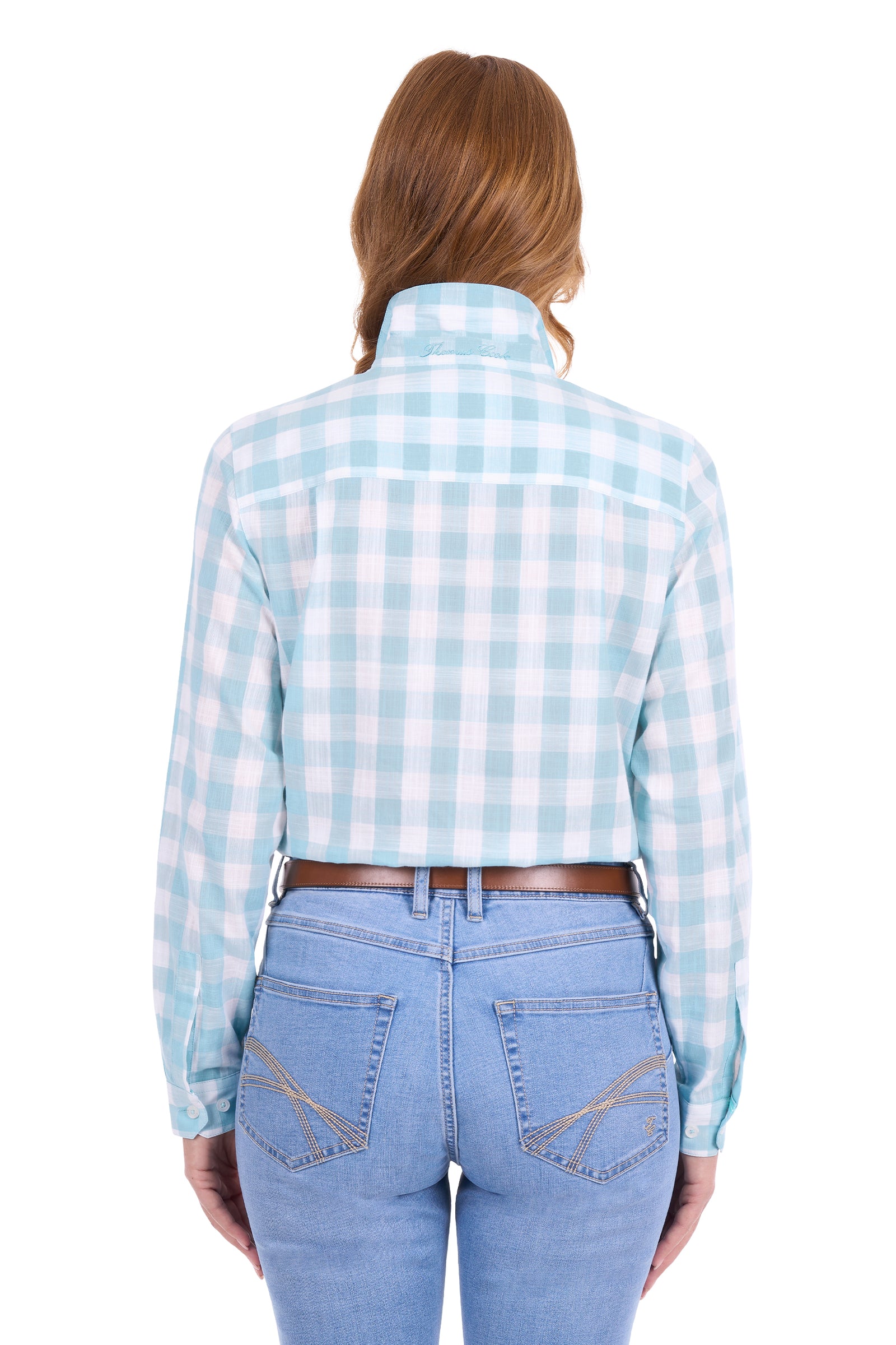 A woman viewed from the back wearing a light blue and white gingham cropped long-sleeve shirt with light blue jeans and a brown belt, against a plain white background.