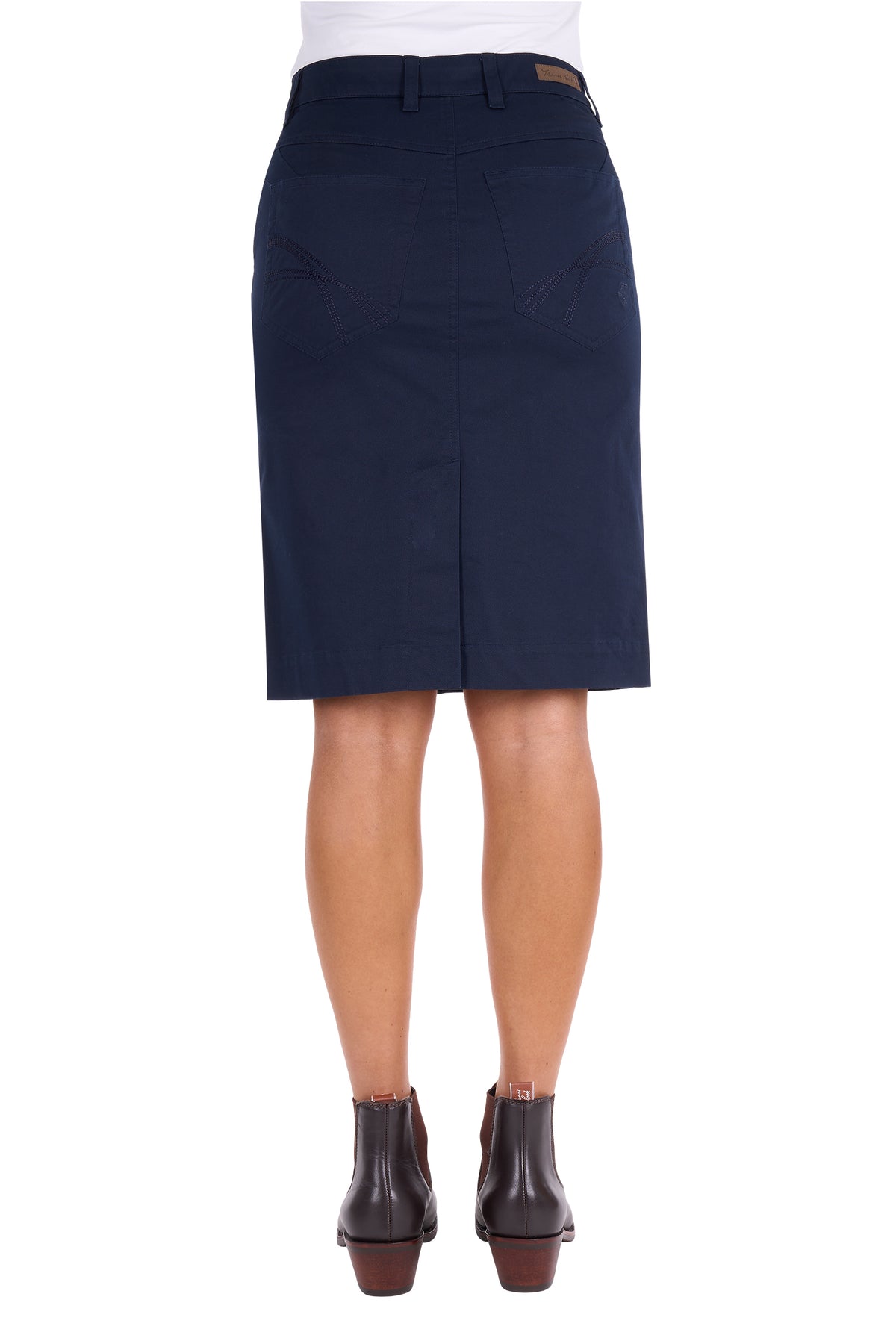 A navy blue knee-length skirt shown on a model from the back, paired with a white top and dark brown ankle boots, against a plain white background.