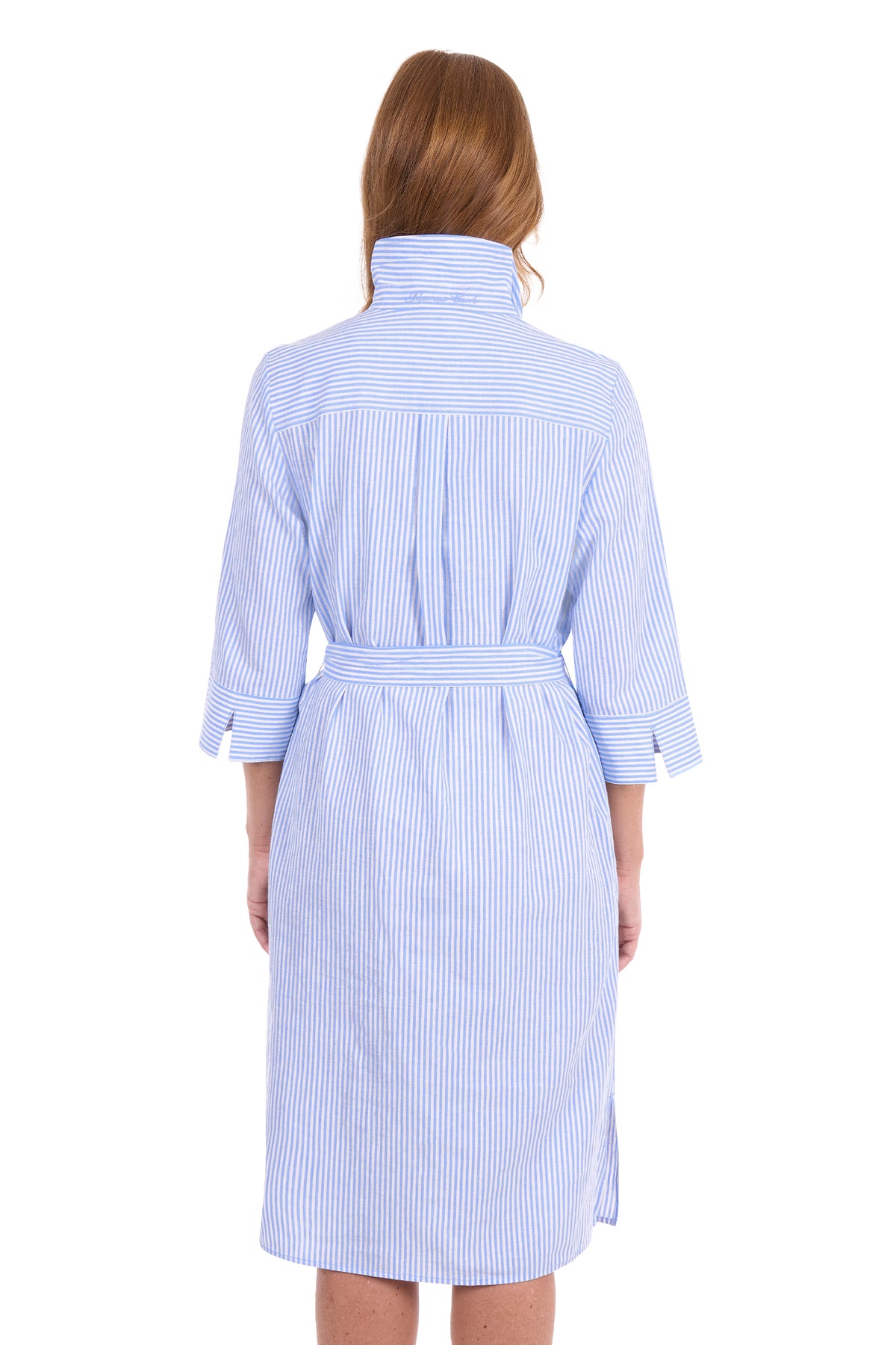 A woman viewed from the back wearing a light blue and white vertically striped bathrobe with a high collar and three-quarter sleeves, set against a plain white background.