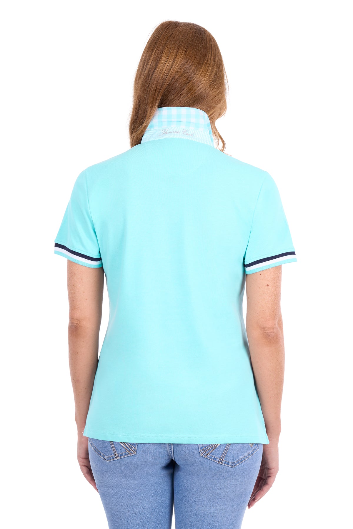 A woman viewed from the back wearing a light aqua short-sleeve polo shirt with a white and blue gingham patterned collar and navy trim on the sleeve cuffs, paired with light blue jeans against a white background.