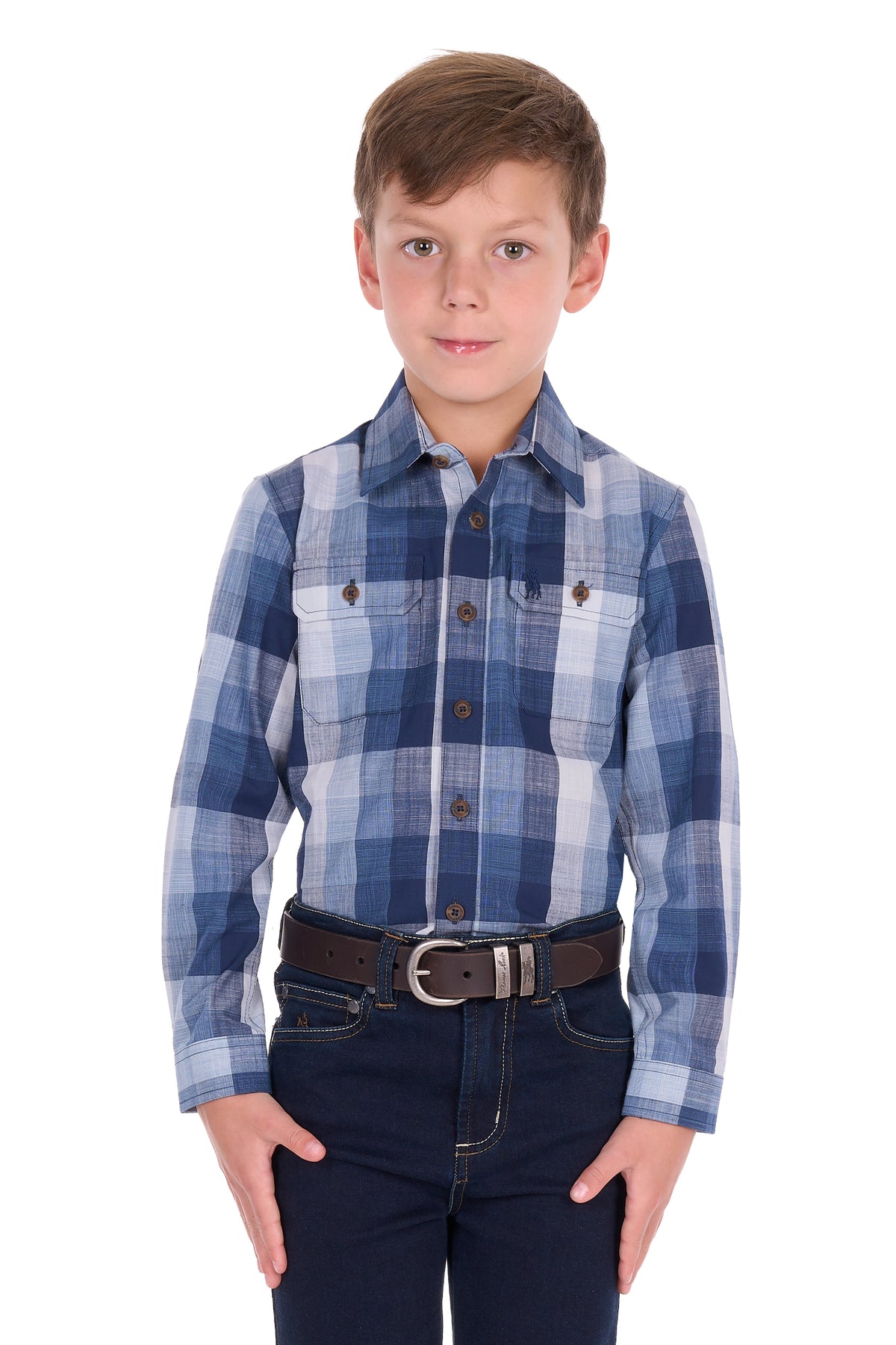 A young boy wearing a blue and white plaid long-sleeve button-down shirt, dark blue jeans, and a brown belt, standing against a solid white background.