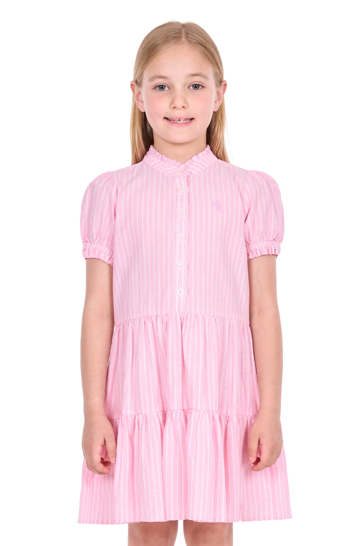 A young girl with blonde hair wearing a pink and white vertically striped tiered dress with short puff sleeves, photographed against a solid white background.