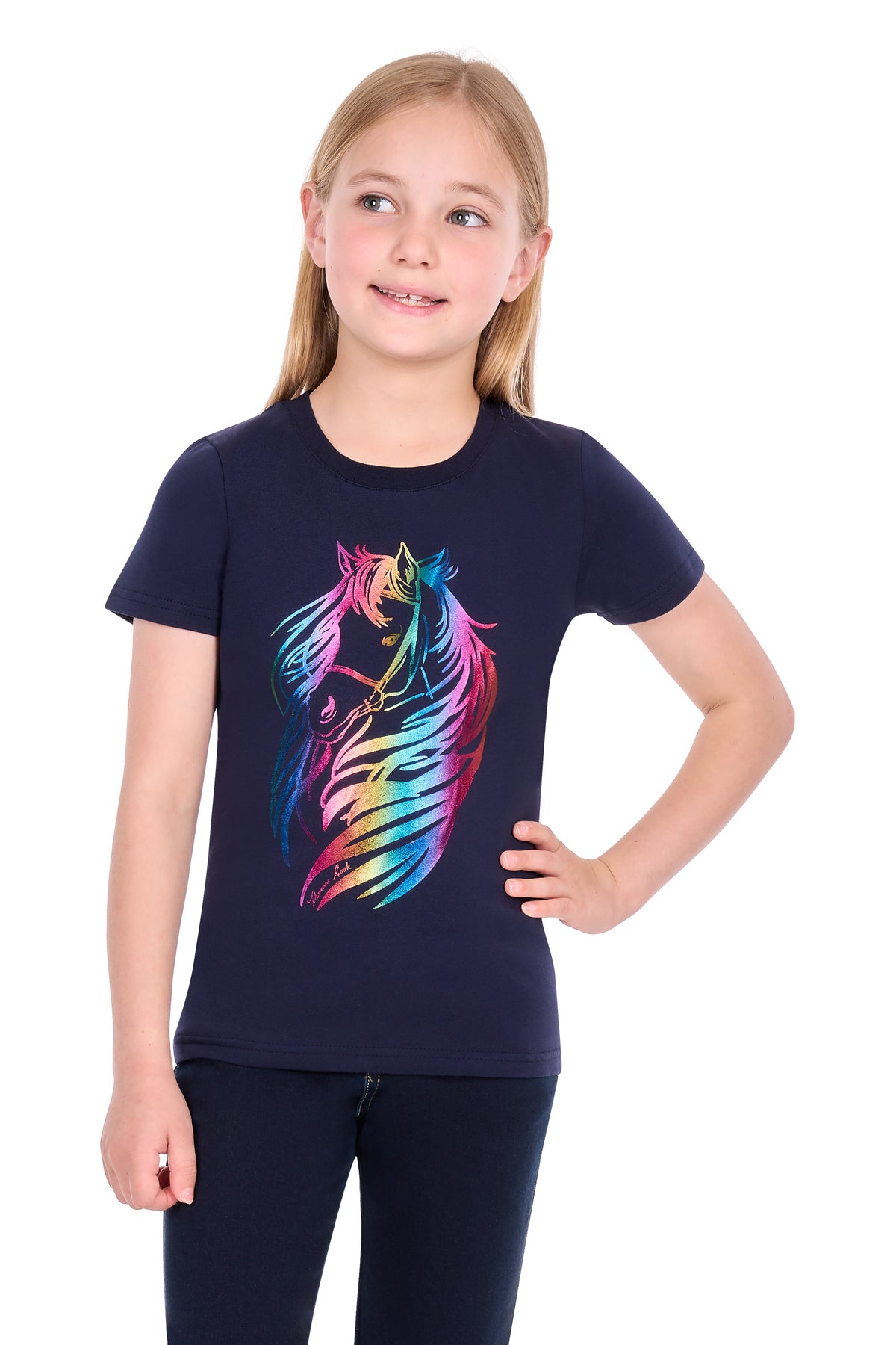 A young girl with blonde hair wearing a navy blue short-sleeve t-shirt with a colorful, vibrant rainbow horse graphic on the front, paired with dark pants, set against a plain white background.