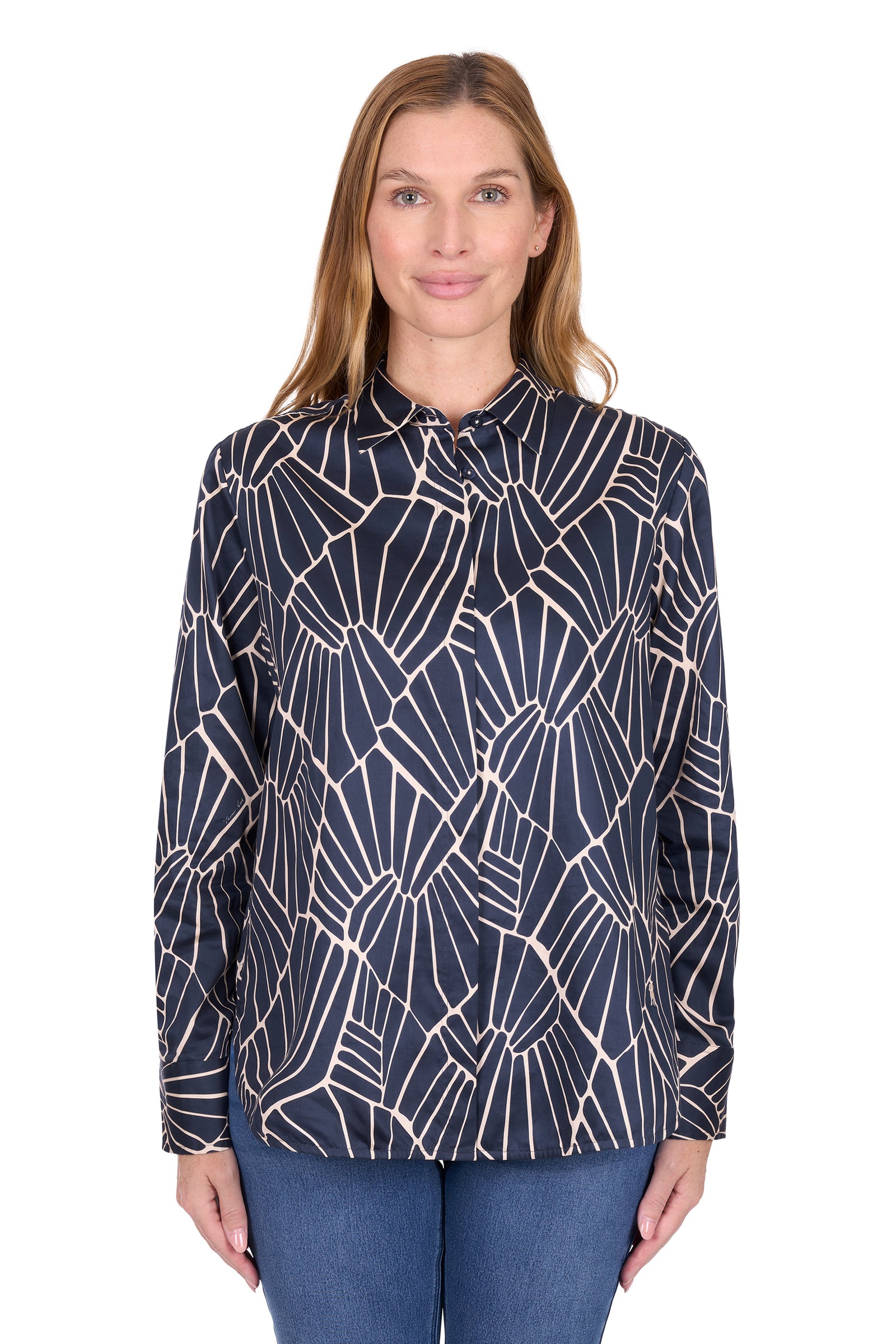 Woman wearing a navy blue patterned blouse on a white background