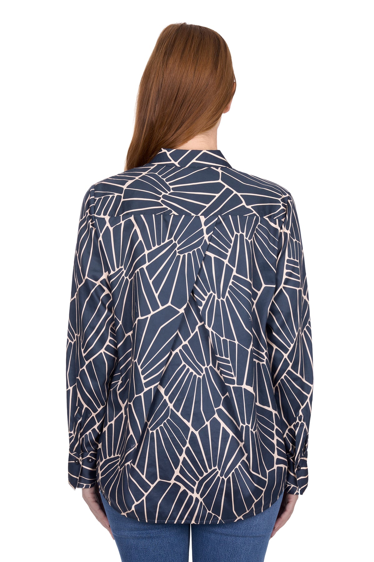 Woman wearing a navy blue patterned blouse on a white background
