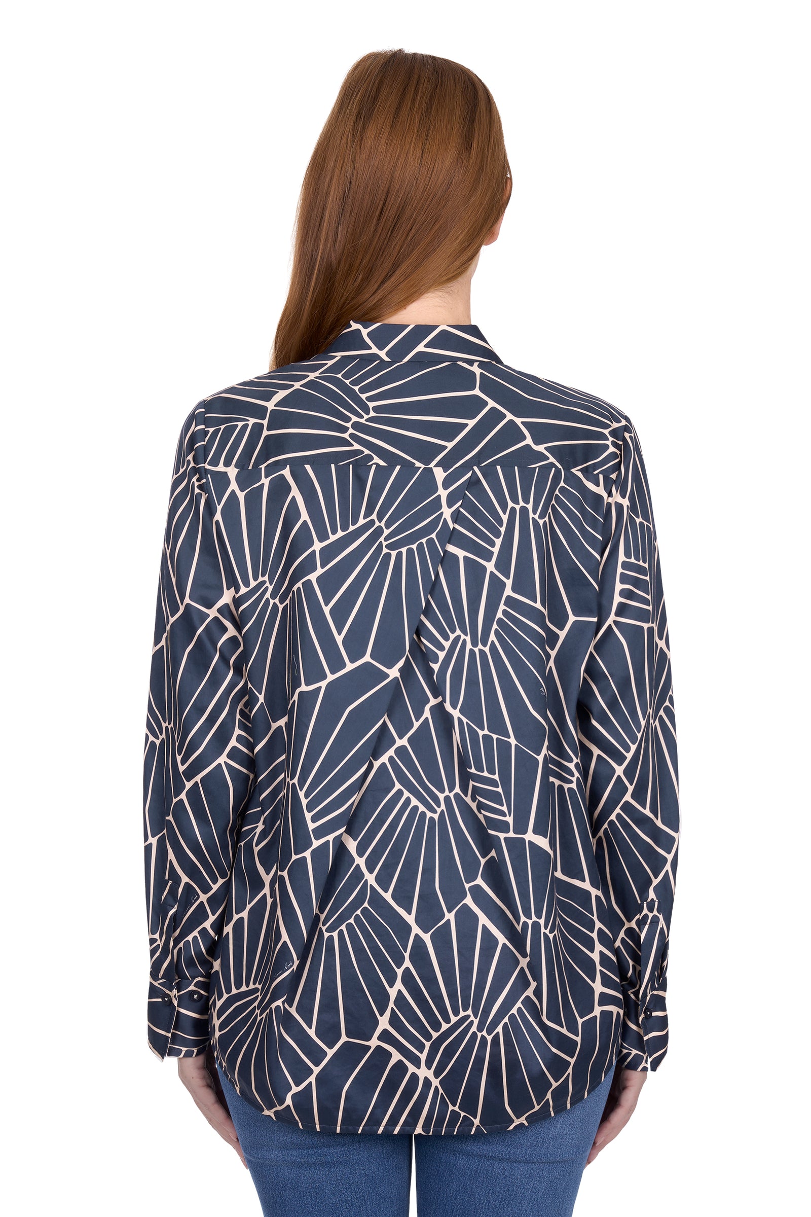 Woman wearing a navy blue patterned blouse on a white background