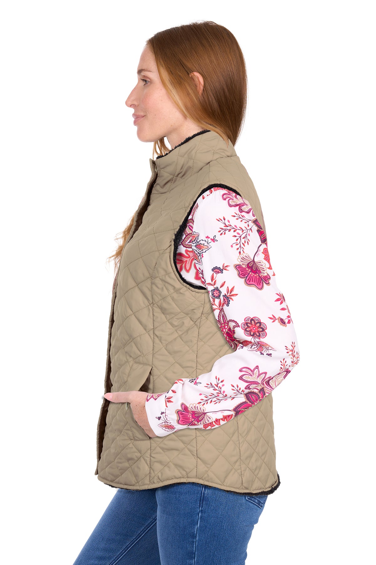 Woman wearing a beige quilted vest with floral sleeves on a white background
