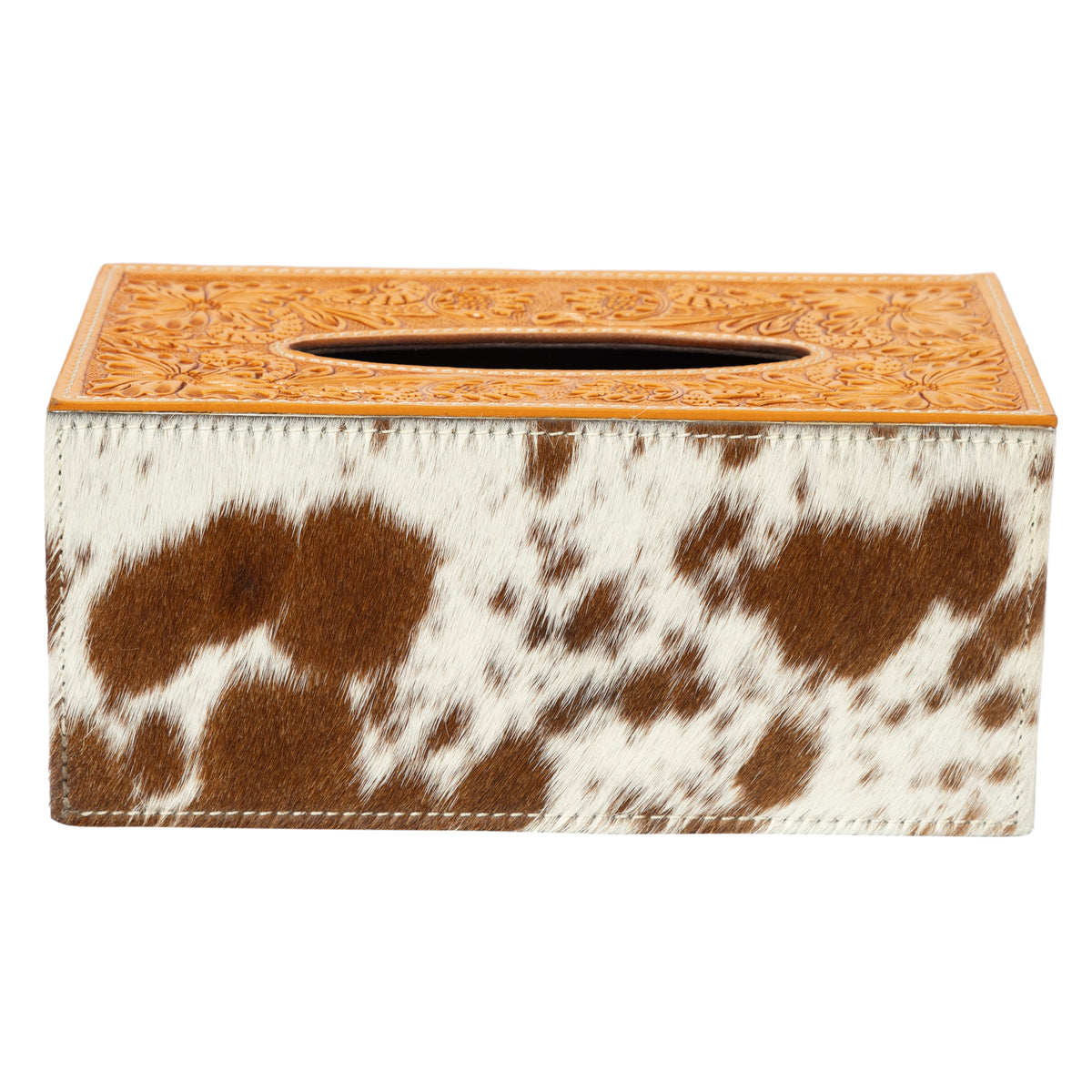 Tissue box cover with cow print design on a white background