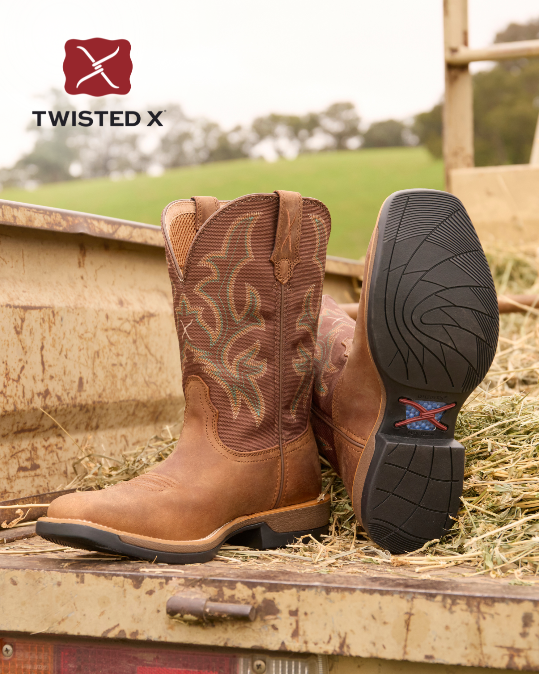 Brown cowboy boots with intricate designs on a wooden surface, featuring the Twisted X logo.