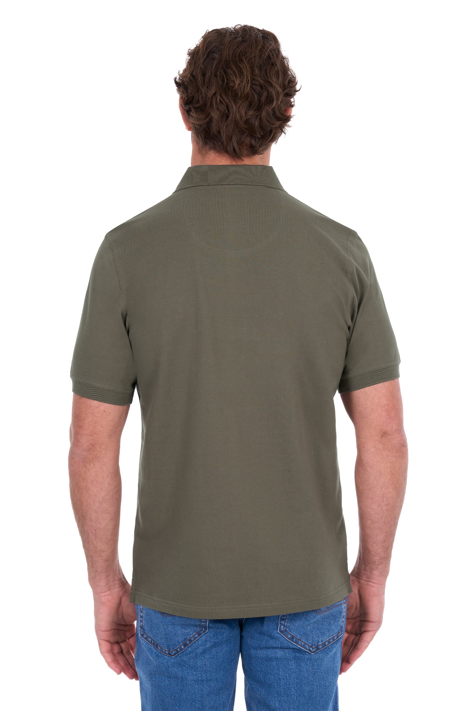 A man viewed from the back wearing an olive green short-sleeve polo shirt and blue jeans against a plain white background.