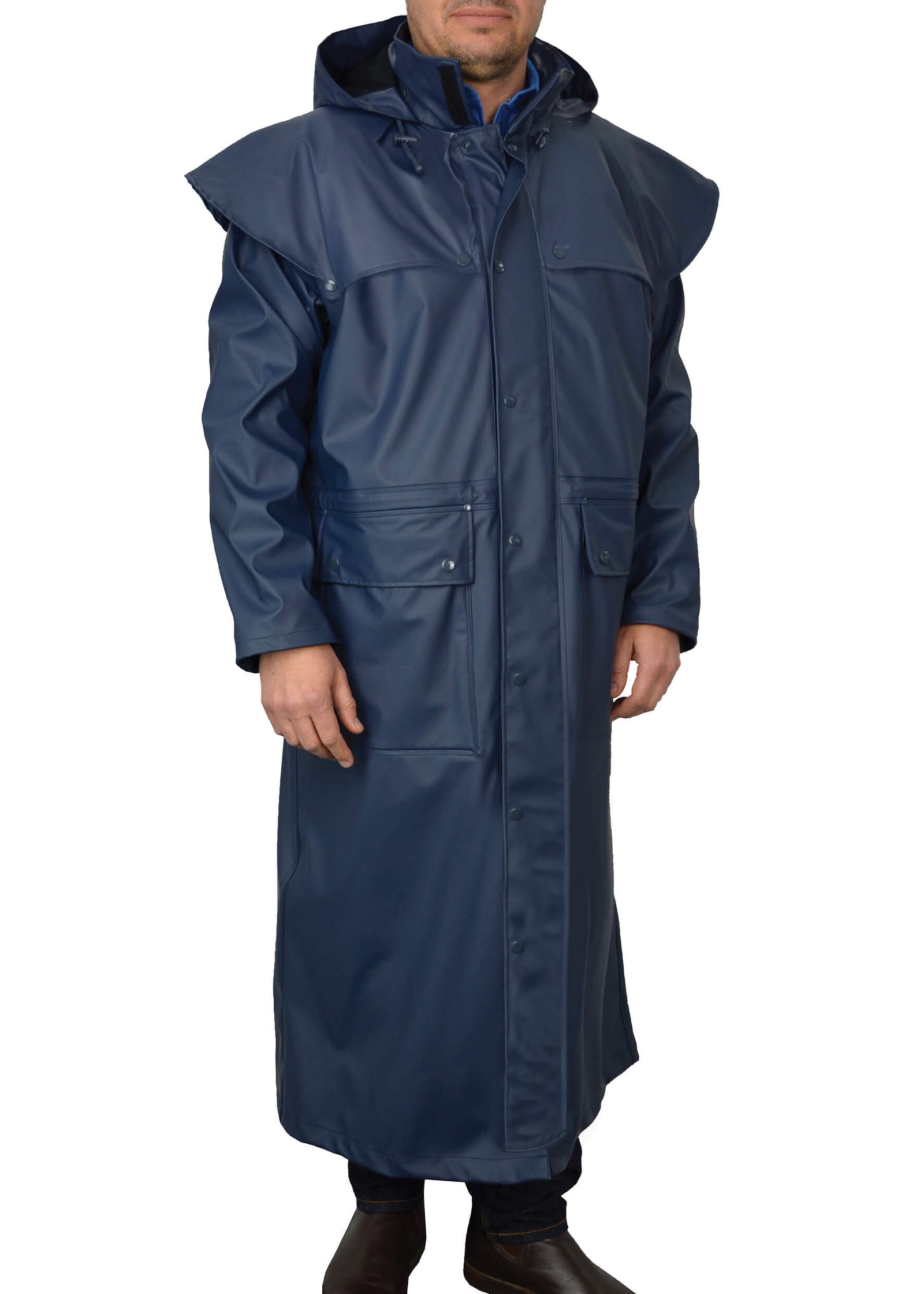 Thomas Cook Pioneer Long Raincoat. A man wearing a navy long raincoat with a hood, featuring patch pockets, a front zipper and snap closure, and elasticated leg straps.
