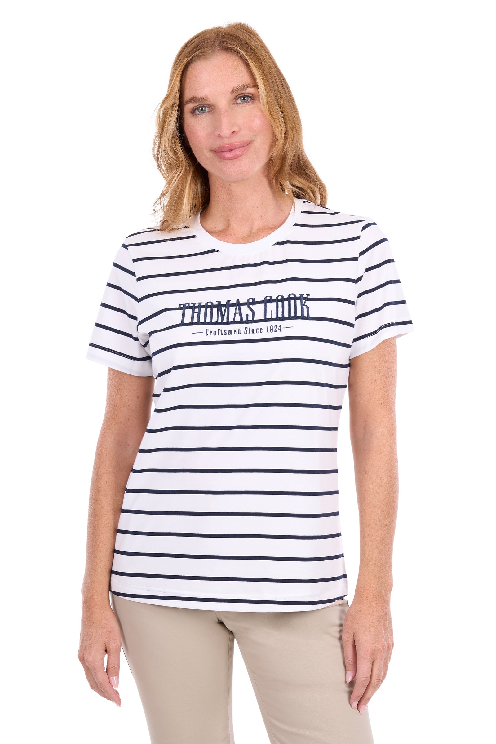 A woman modeling a white short-sleeve crewneck t-shirt with thin navy horizontal stripes and 'THOMAS COOK' printed across the chest.