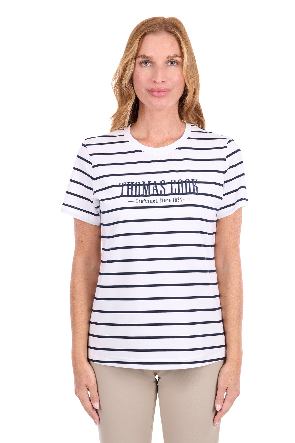 A woman modeling a white short-sleeve t-shirt with navy blue horizontal stripes and 'THOMAS COOK' printed across the chest, paired with beige pants, against a plain white background.