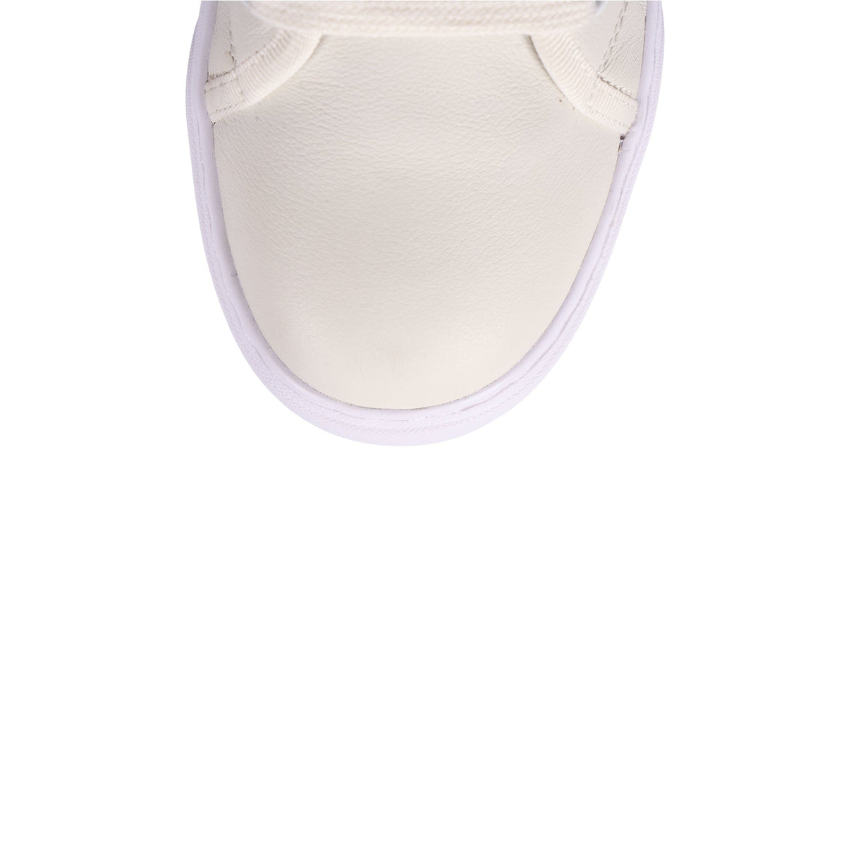 A close-up top-down view of a white leather sneaker toe cap with a white sole, set against a solid white background.