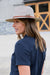Thomas Cook Hampton Hat. Beige straw hat with a brown belt on a white background