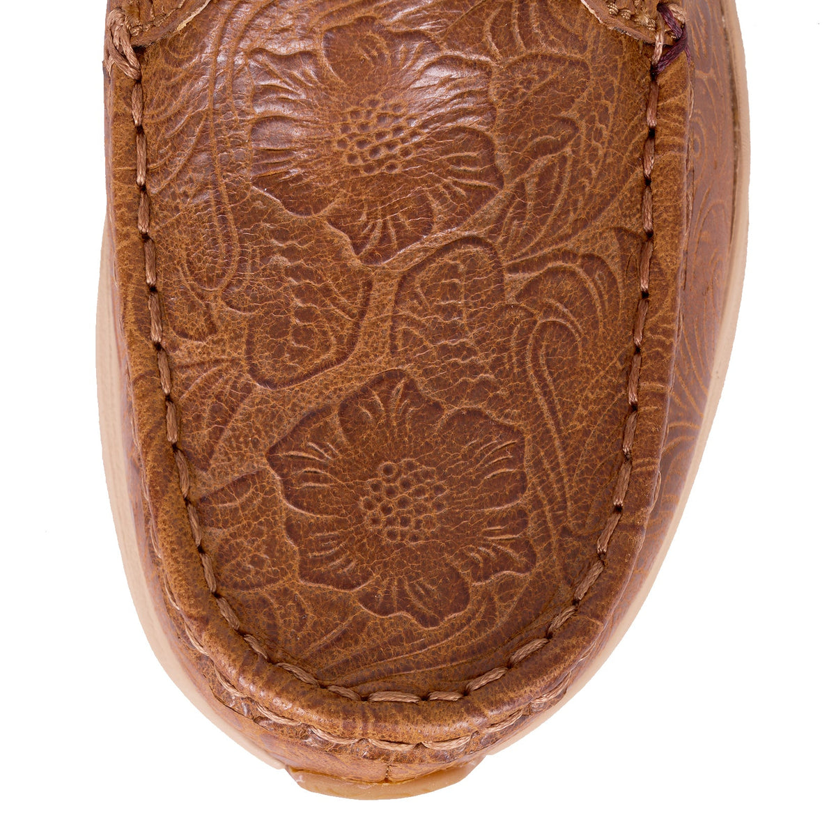 Twisted X Women's Ultralite X Casual . Close-up of a brown leather moccasin with floral embossing on a white background