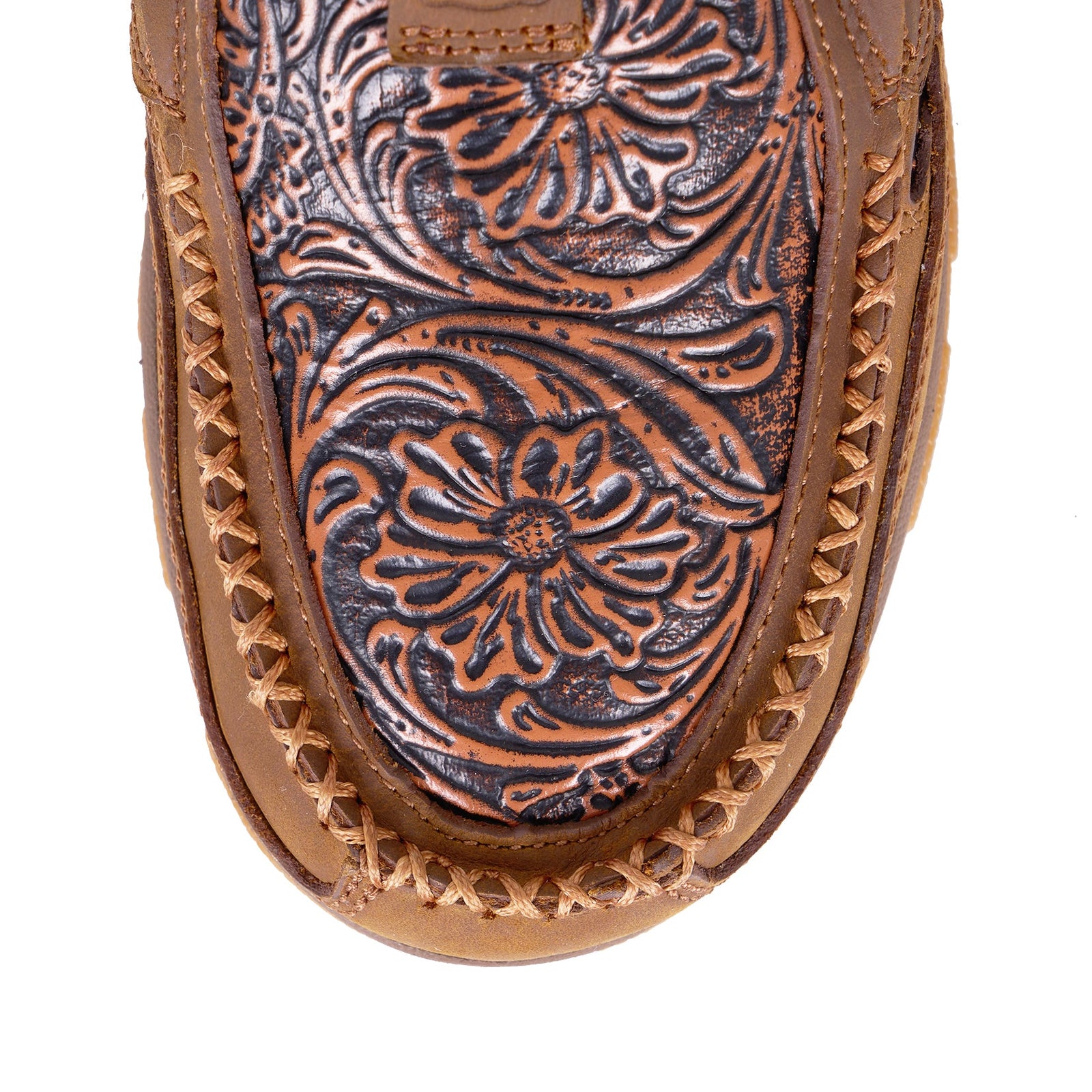Twisted X Women's Tooled CellStretch Mocs Slip On. Close-up of a brown leather shoe with intricate floral patterns on a white background