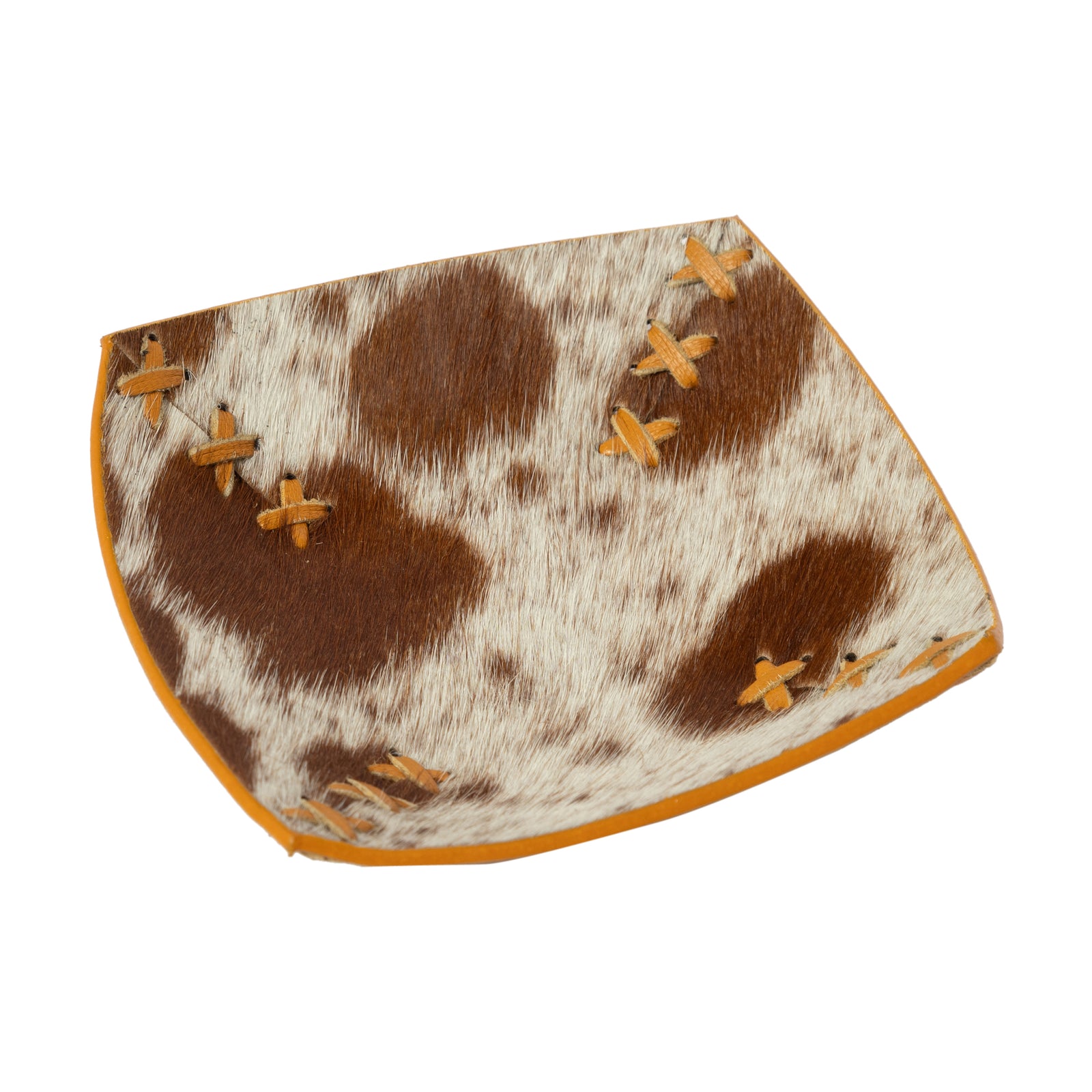 Cowhide saddle pad with brown and white pattern and orange stitching on a white background