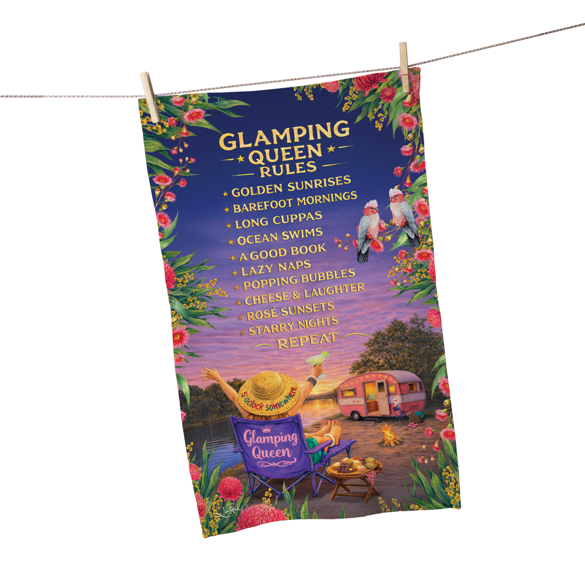 A decorative hanging towel or poster featuring the text 'Glamping Queen Rules' and a colorful illustrated scene with a camper, chairs, flowers, and birds, suspended by clips from a string line against a light gray background.