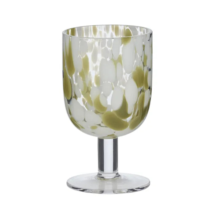 Freckle Glass Goblet. Wine glass with green and white abstract pattern on a white background