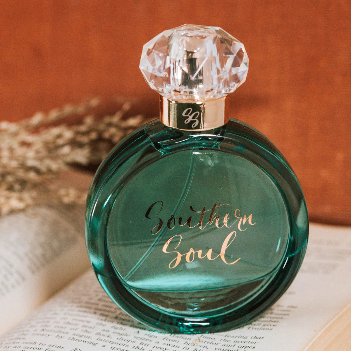 Perfume bottle labeled 'Southern Soul' on an open book with a warm background