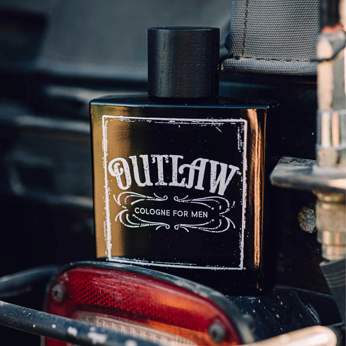 Outlaw cologne bottle on a vintage vehicle