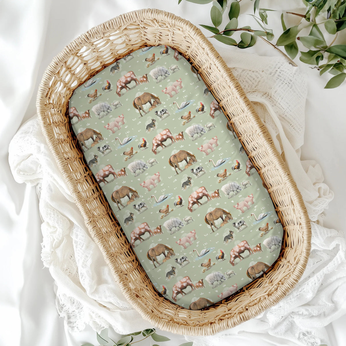 Wicker basket with a patterned cover featuring animals on a white fabric background