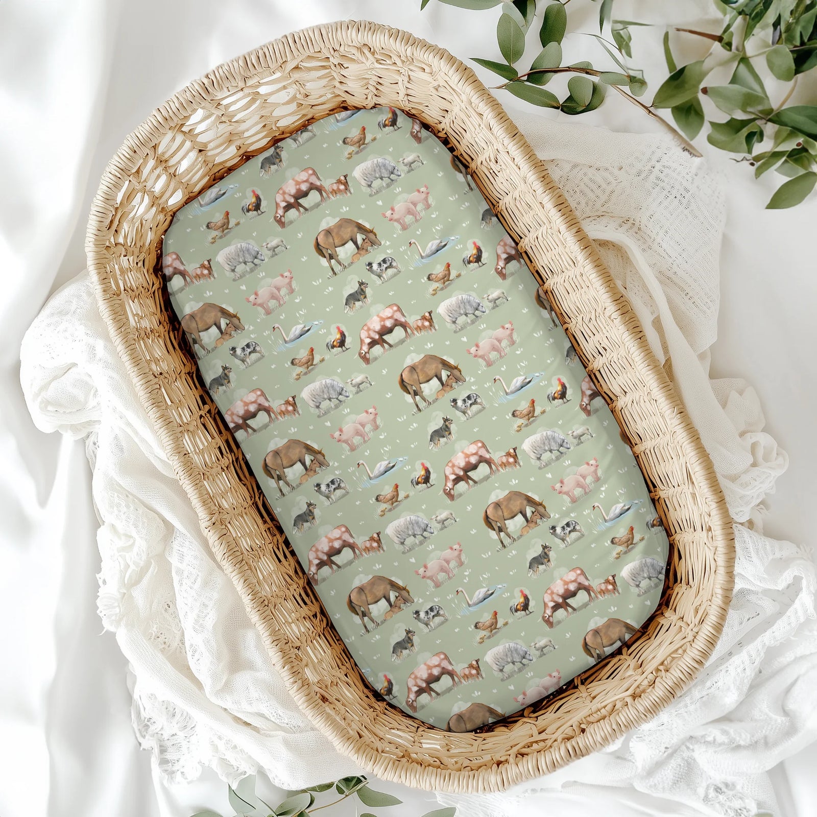 Wicker basket with a patterned cover featuring animals on a white fabric background