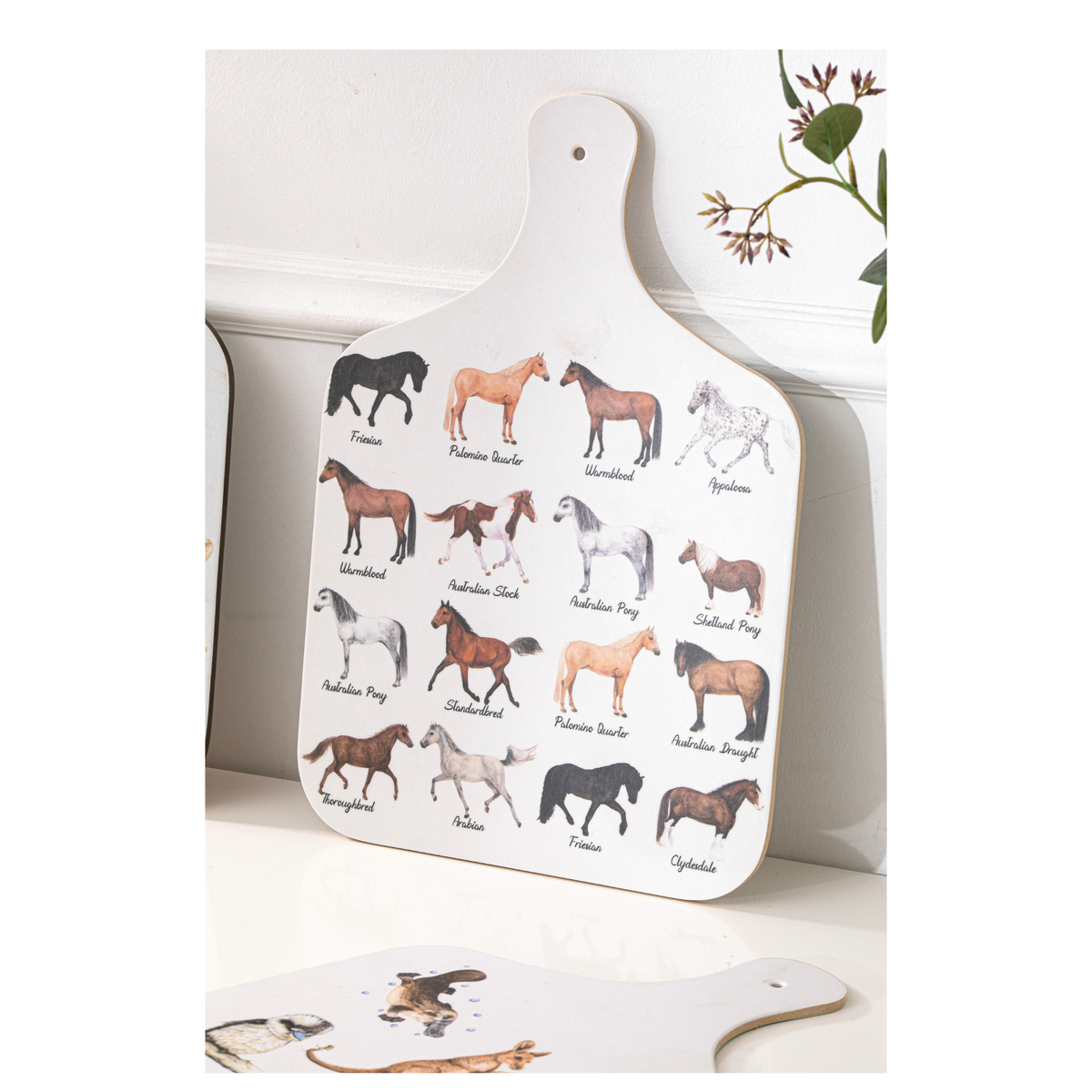 White cutting board with horse illustrations on a white background