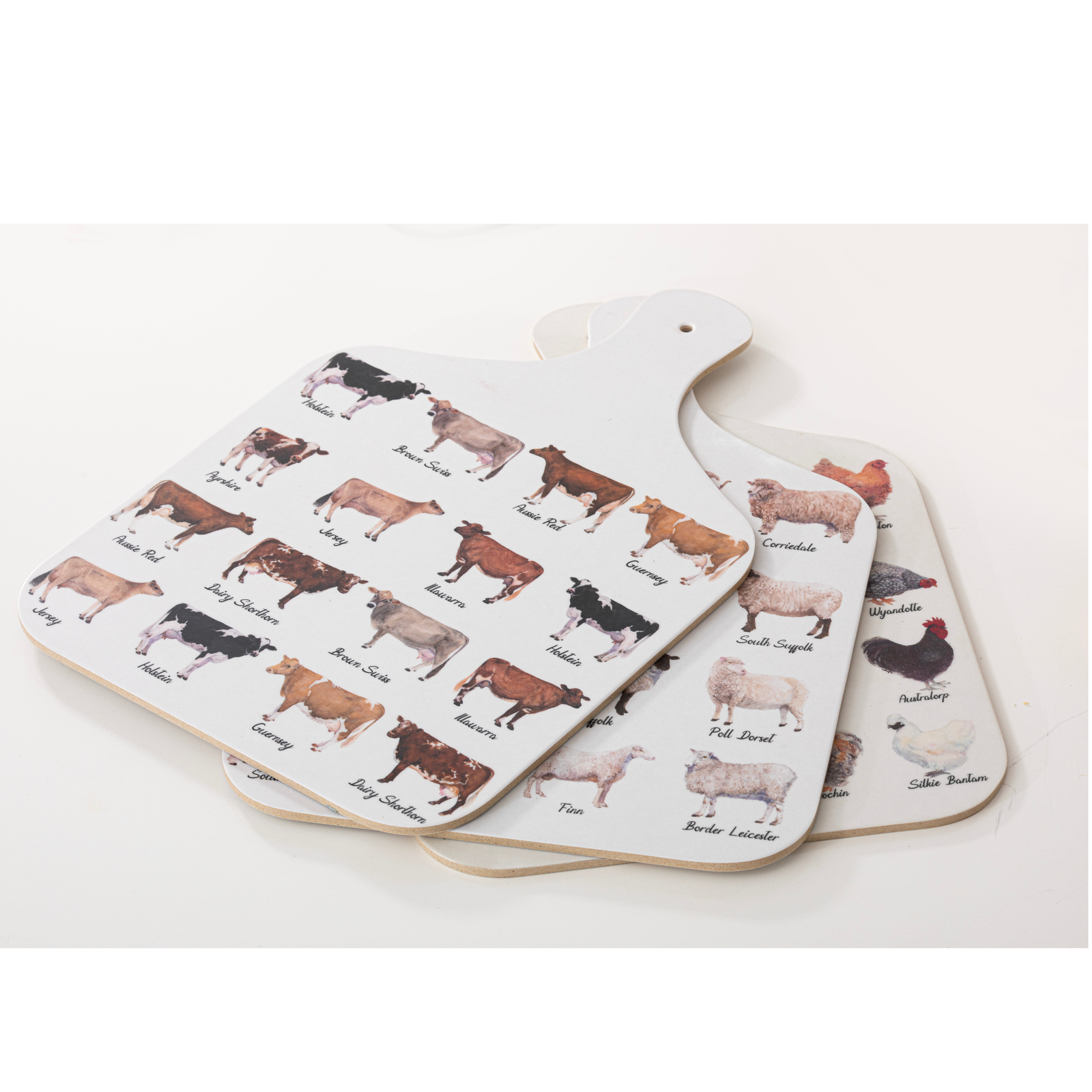 Paddle-shaped cutting board with cow breed illustrations on a white background