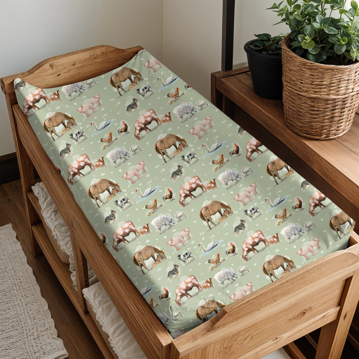 Wooden crib with a green mattress featuring animal pattern, next to a wooden shelf with plants.