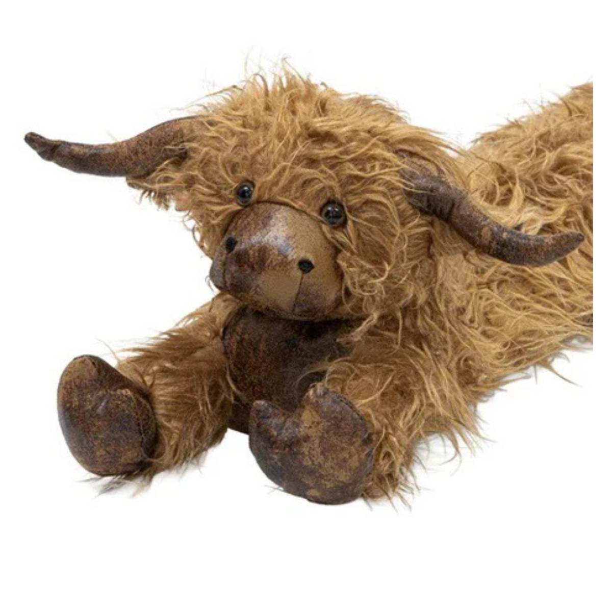 Plush toy Highland cow with brown fur and horns on a white background