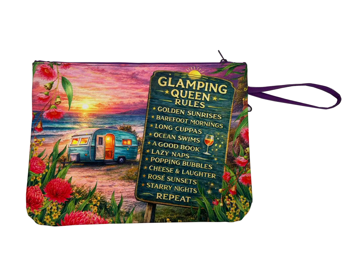 A rectangular zip pouch with a colorful printed design featuring a retro trailer by a sunset beach, flowers, and a large sign that reads 'Glamping Queen Rules' with a list of relaxing activities. The pouch has a purple wrist strap and is shown on a plain white background.