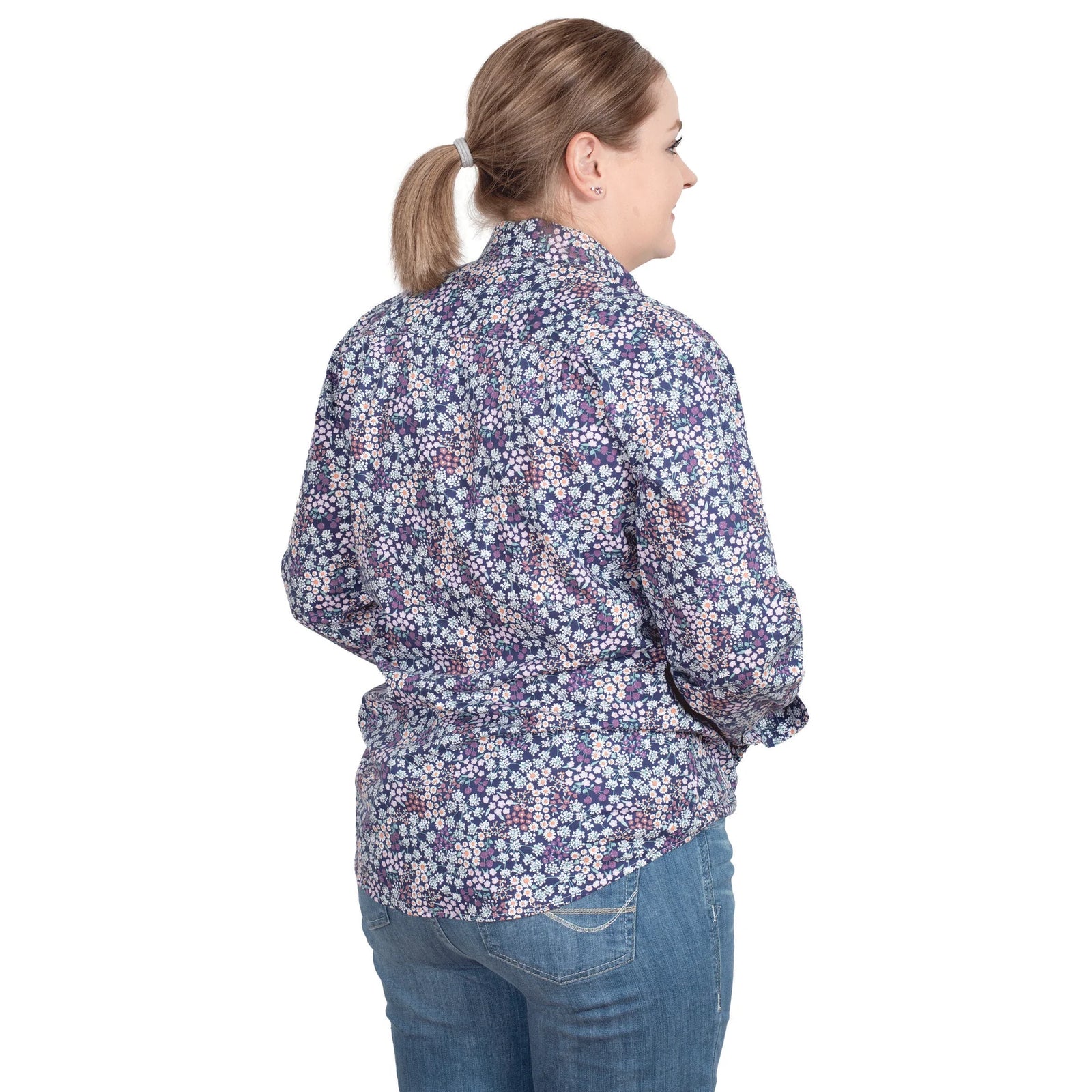 Just Country Women's Georgie Half Button L/S Shirt. A woman wearing a long-sleeved floral button-up shirt and jeans.