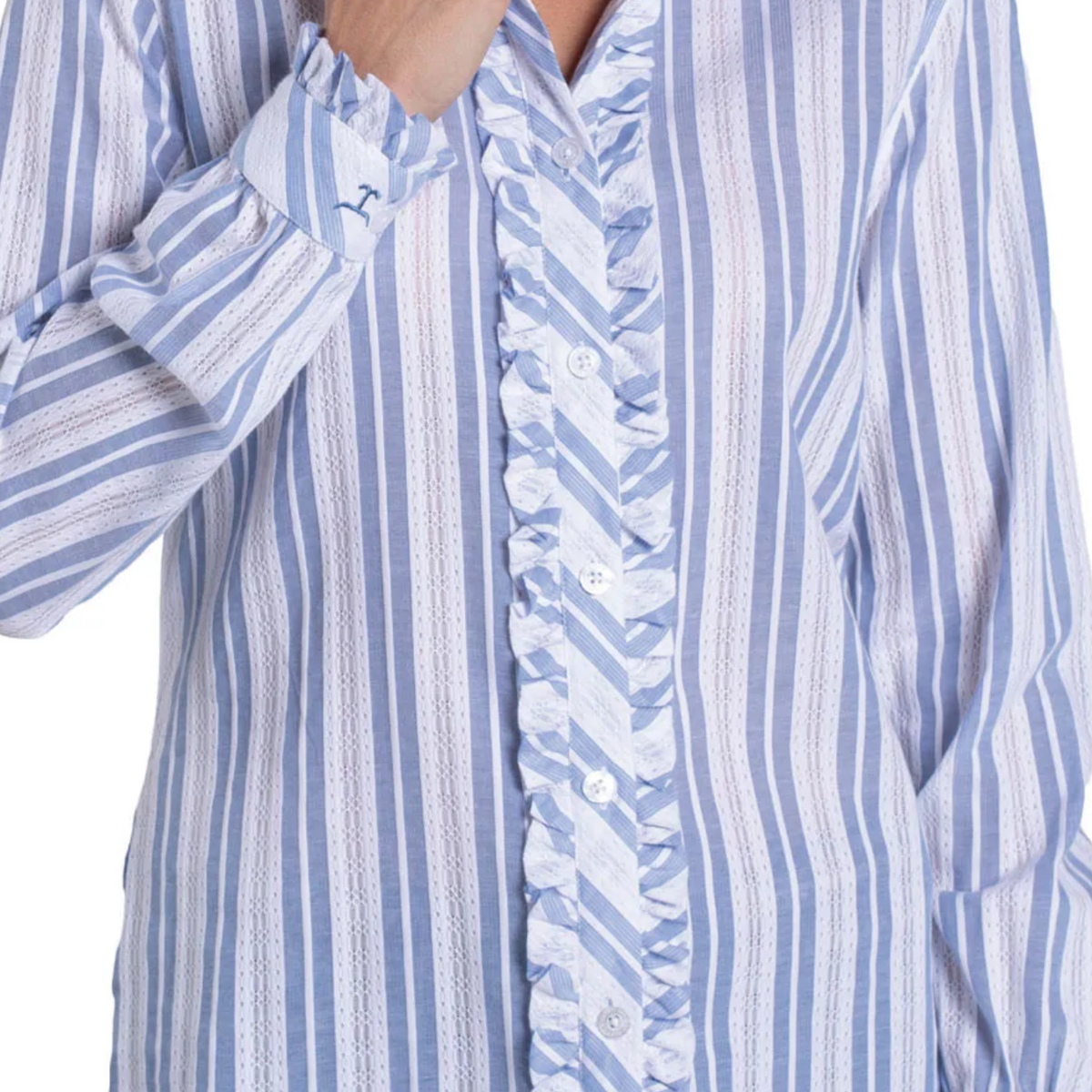 Close-up of a blue and white striped shirt with ruffled details.